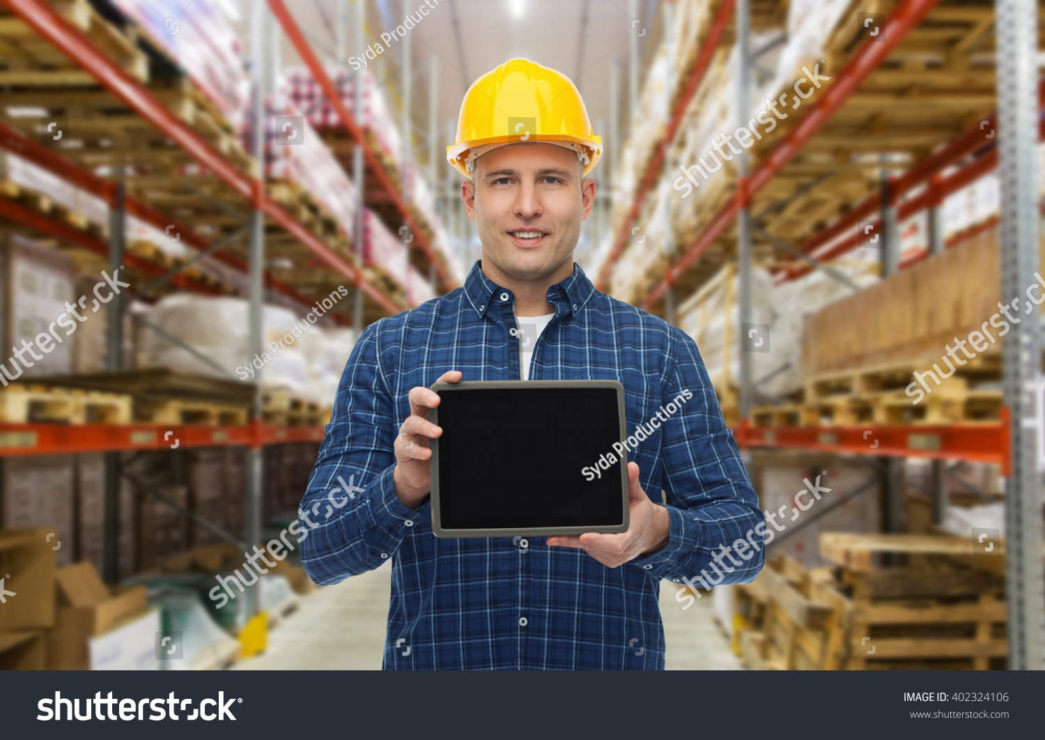 wholesale, logistic, business, export and people concept - happy man or manager showing tablet pc computer blank screen over warehouse background #402324106
