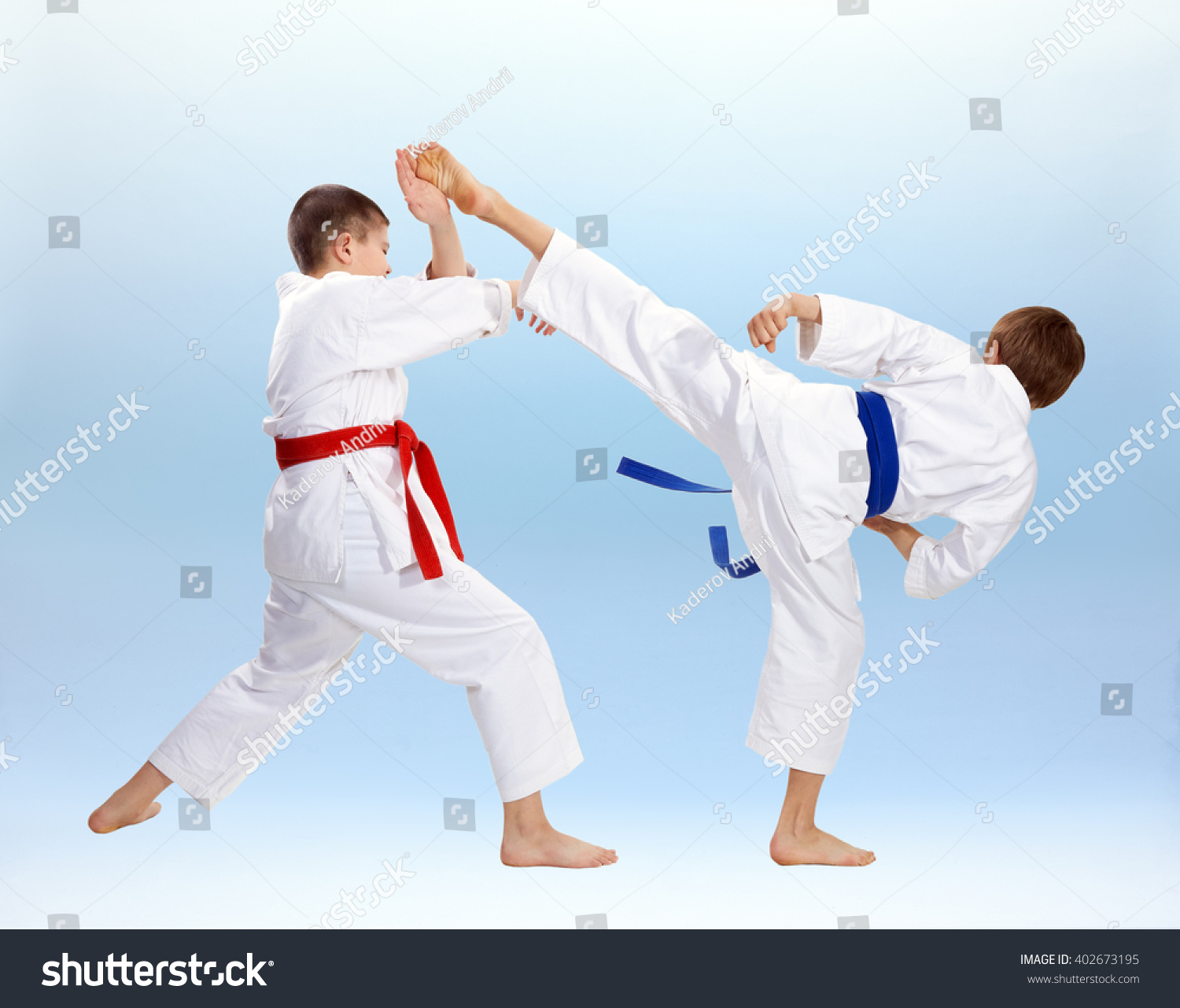 High kick and block are training boys in karategi #402673195