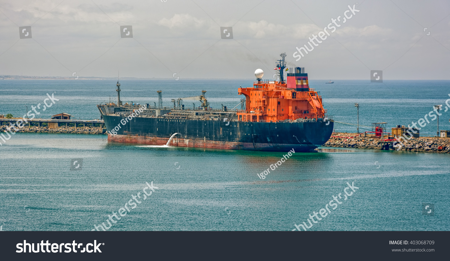 Crude oil tanker pumping ballast water in Lagos, Nigeria, Africa #403068709