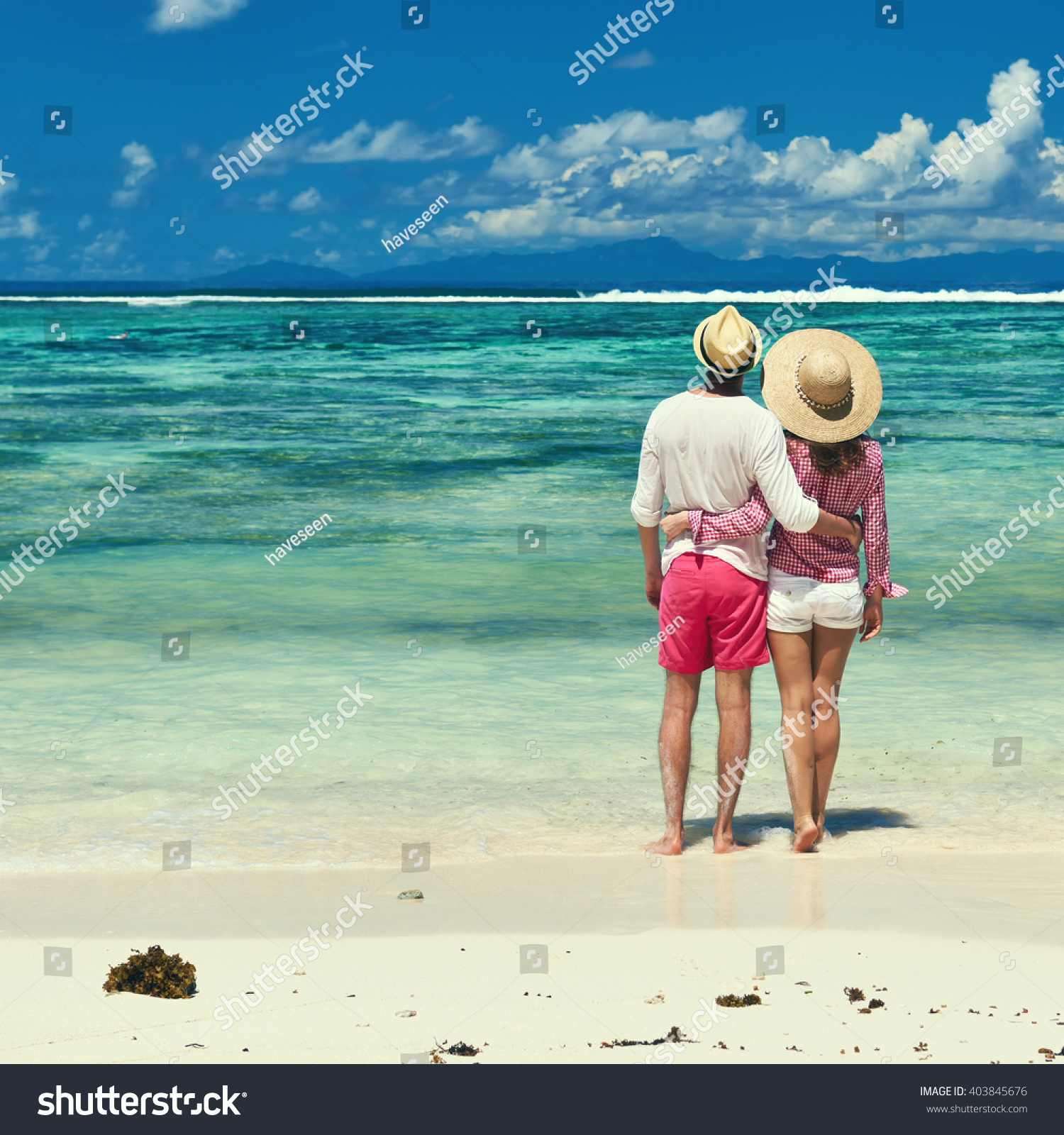 Couple on a tropical beach at Seychelles #403845676