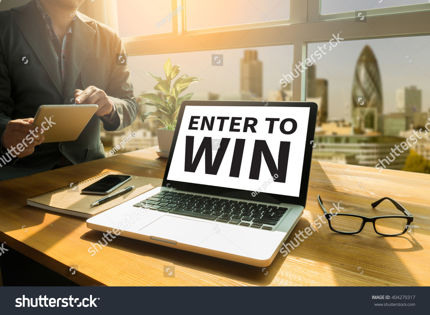 ENTER TO WIN Thoughtful male person looking to the digital tablet screen, laptop screen,Silhouette and filter sun #404270317