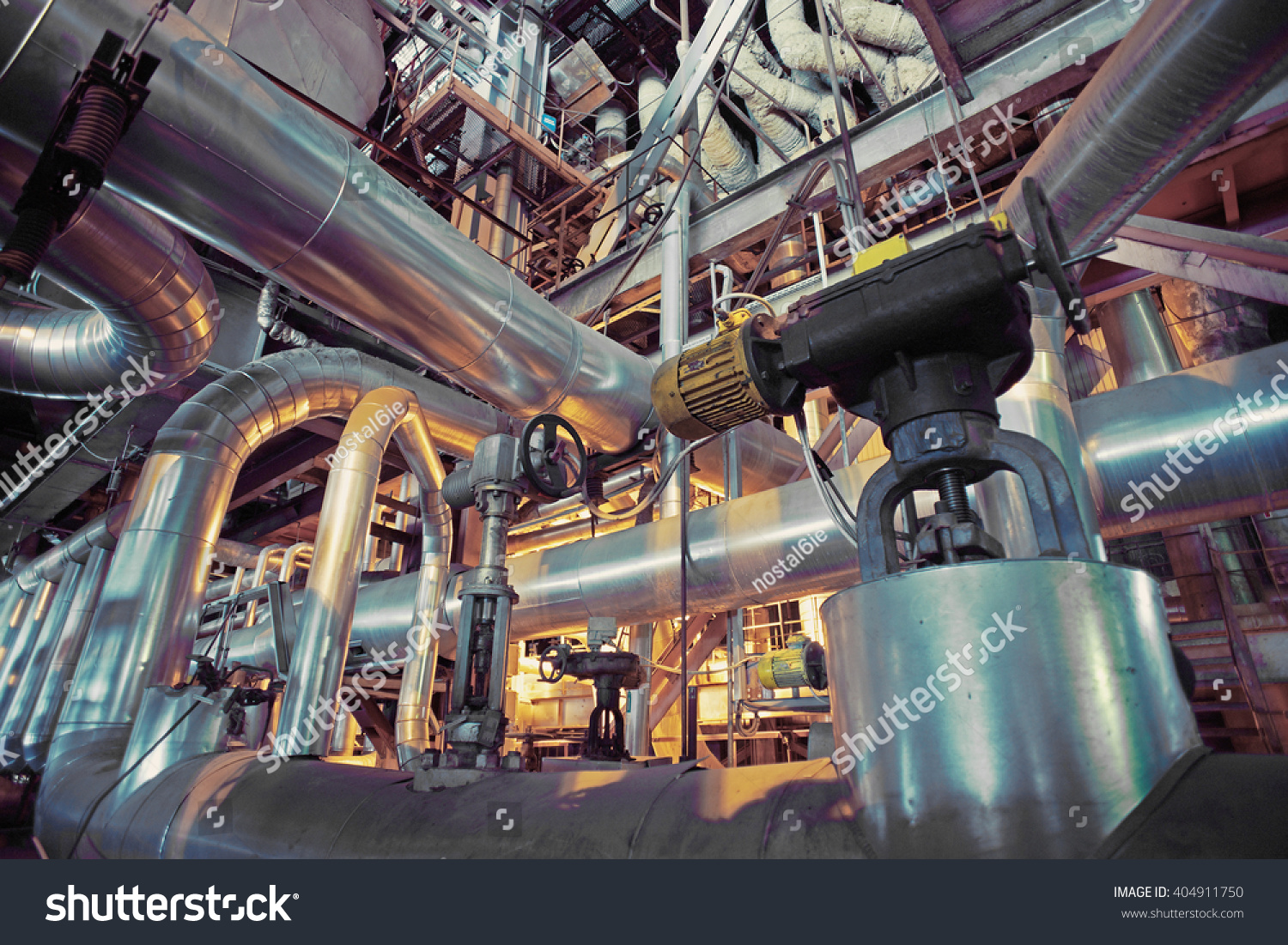 Equipment, cables and piping as found inside of a industrial power plant #404911750
