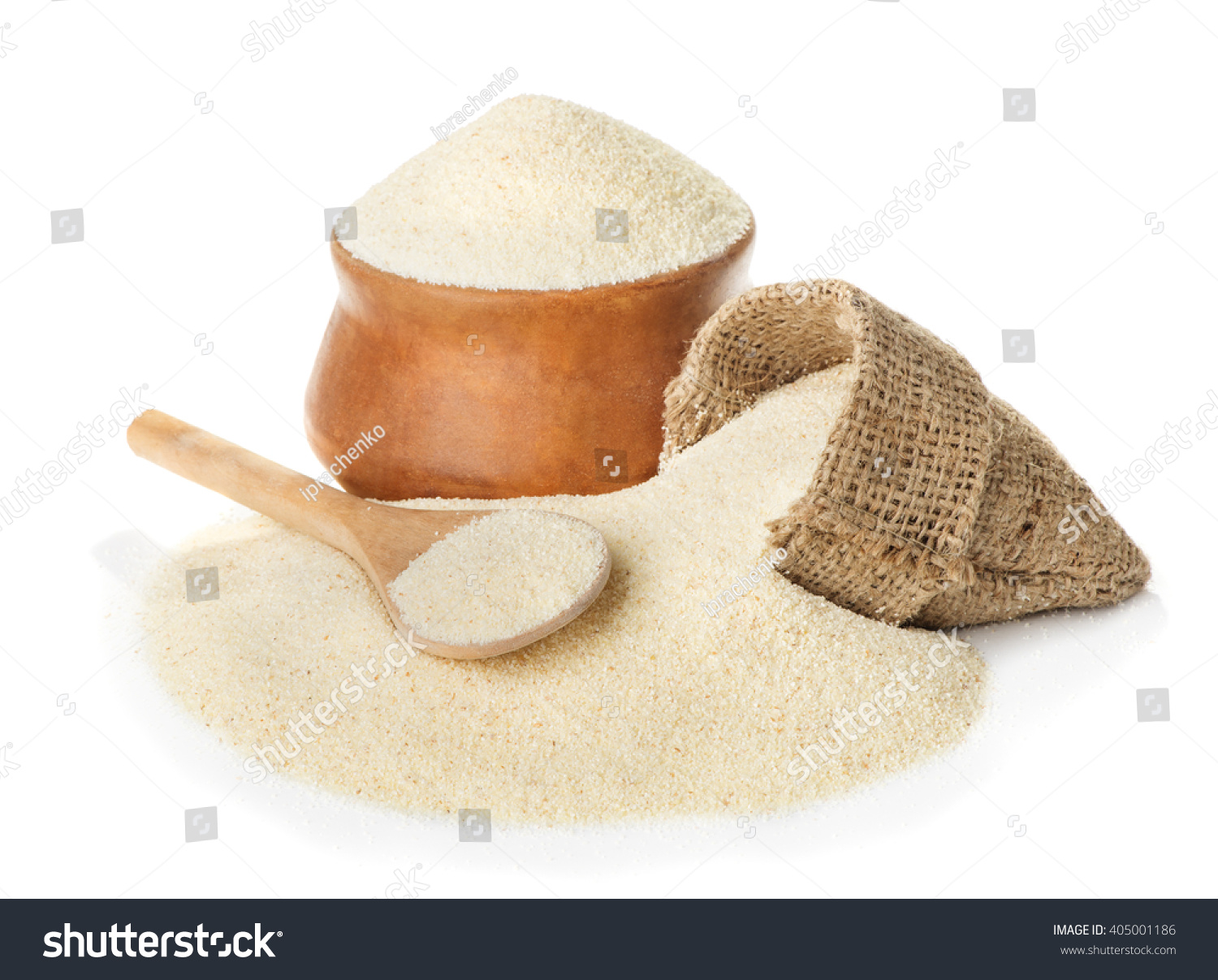Raw unprepared semolina in bowl and spoon close-up isolated on white background #405001186