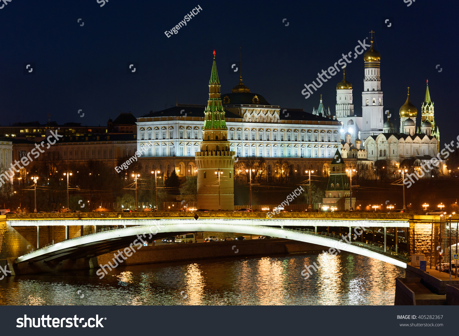 Beautiful view of architecture Moscow redbrick Kremlin landmarks at night with bridge on river Moscow with reflected lights from street and other buildings and  sky as a background. Capital of Russia. #405282367