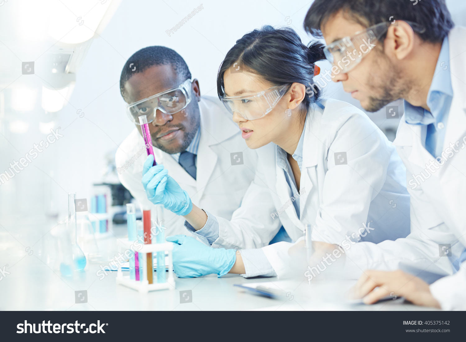 Group of scientists studying reaction of some chemical #405375142
