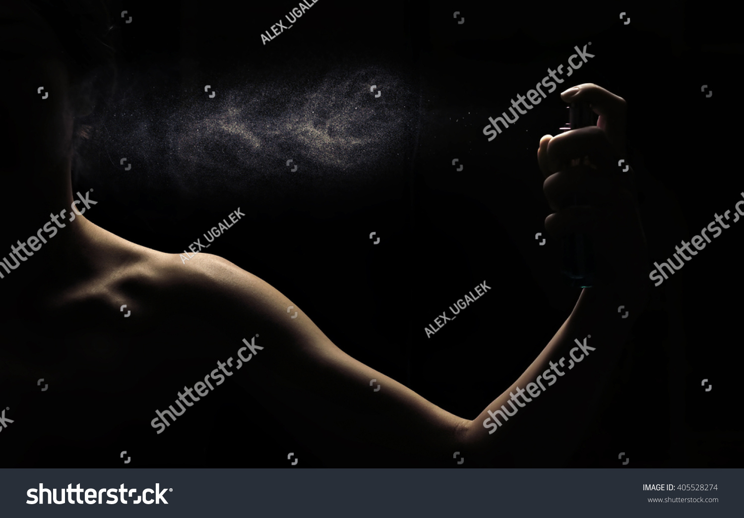 Woman's perfume in the hand on black background  #405528274