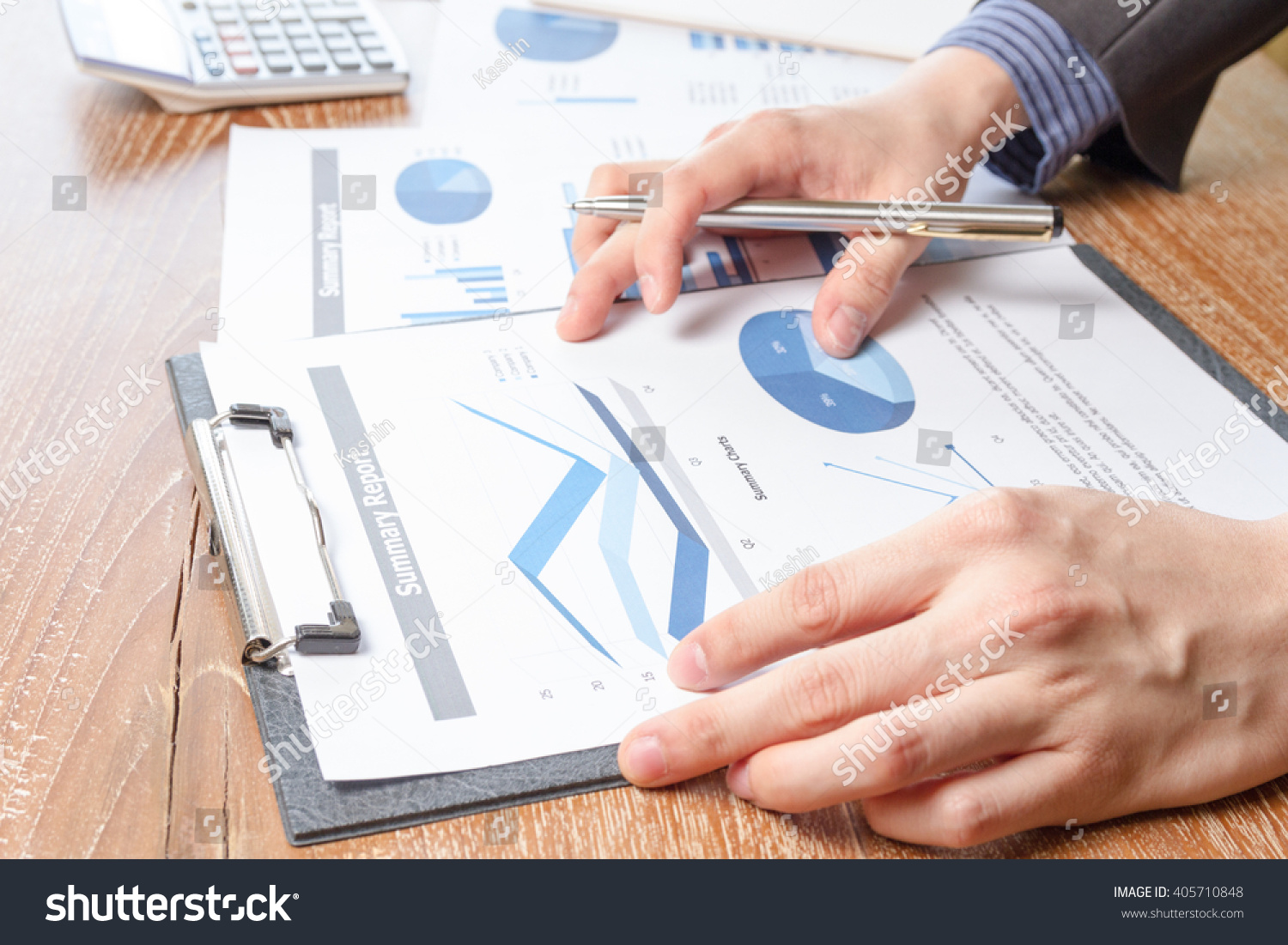 business man analyzing graph and chart document report, business performance concept #405710848