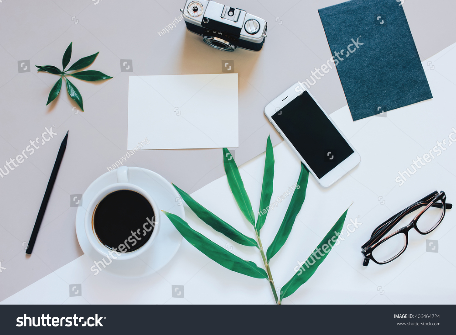 Creative flat lay photo of workspace desk with smartphone, coffee, film camera, blank paper and envelope with copy space background, minimal style
 #406464724