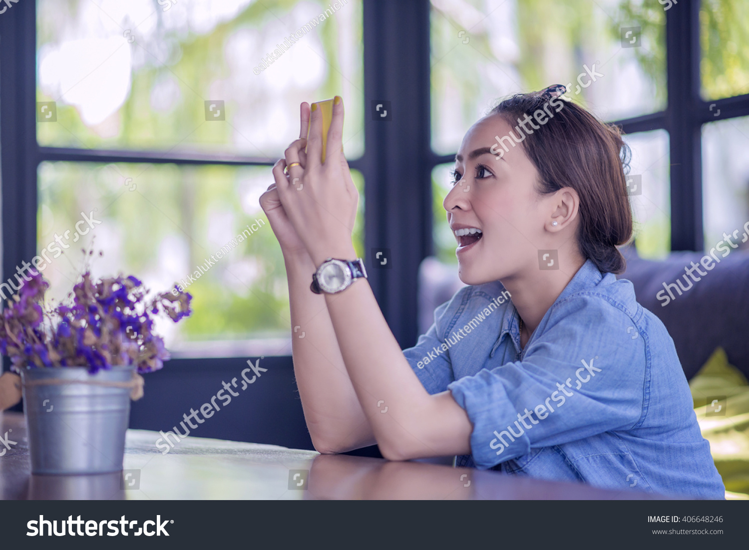 Beautiful young Asian woman being looking at phone seeing surprised message news or photos there with disgusting emotion on her face #406648246
