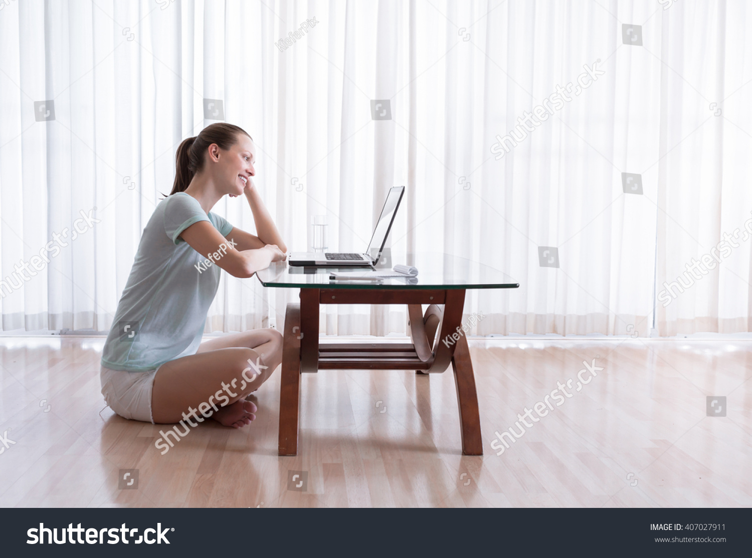 Young female working on her computer.  #407027911
