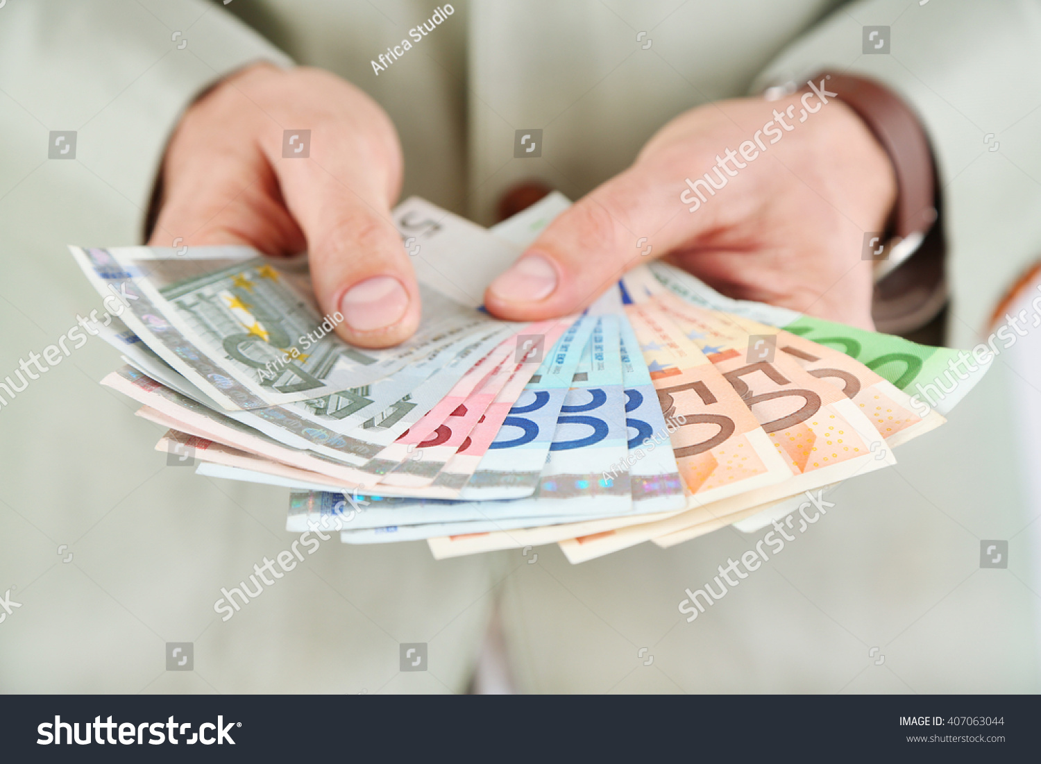 Male hands holding euros closeup #407063044