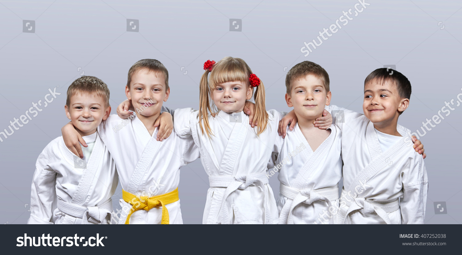 On a gray background little athletes in karategi #407252038