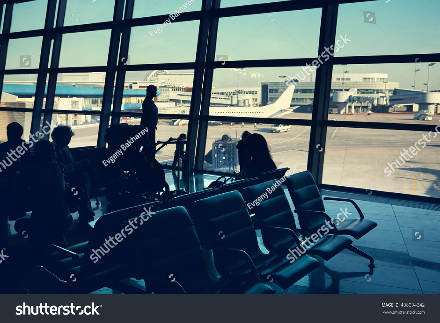 silhouette of a group of people in an airport waiting hall. travel business concept #408094342