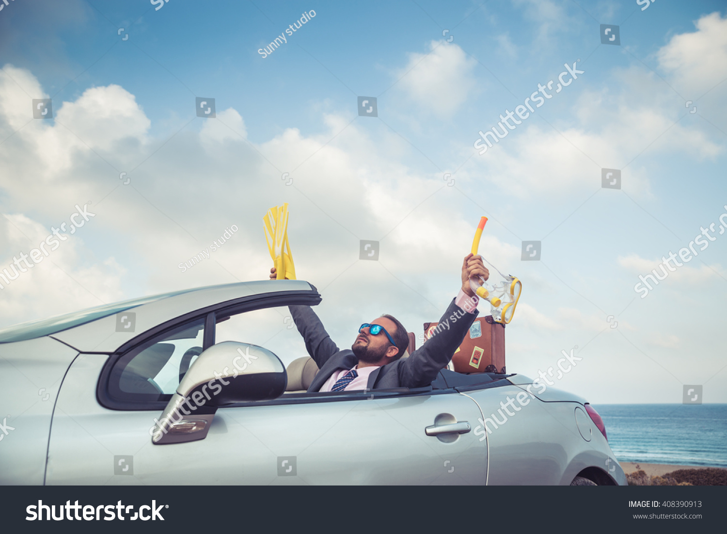 Successful young businessman on a beach. Man sitting in the cabriolet classic car. Summer vacations and travel concept #408390913