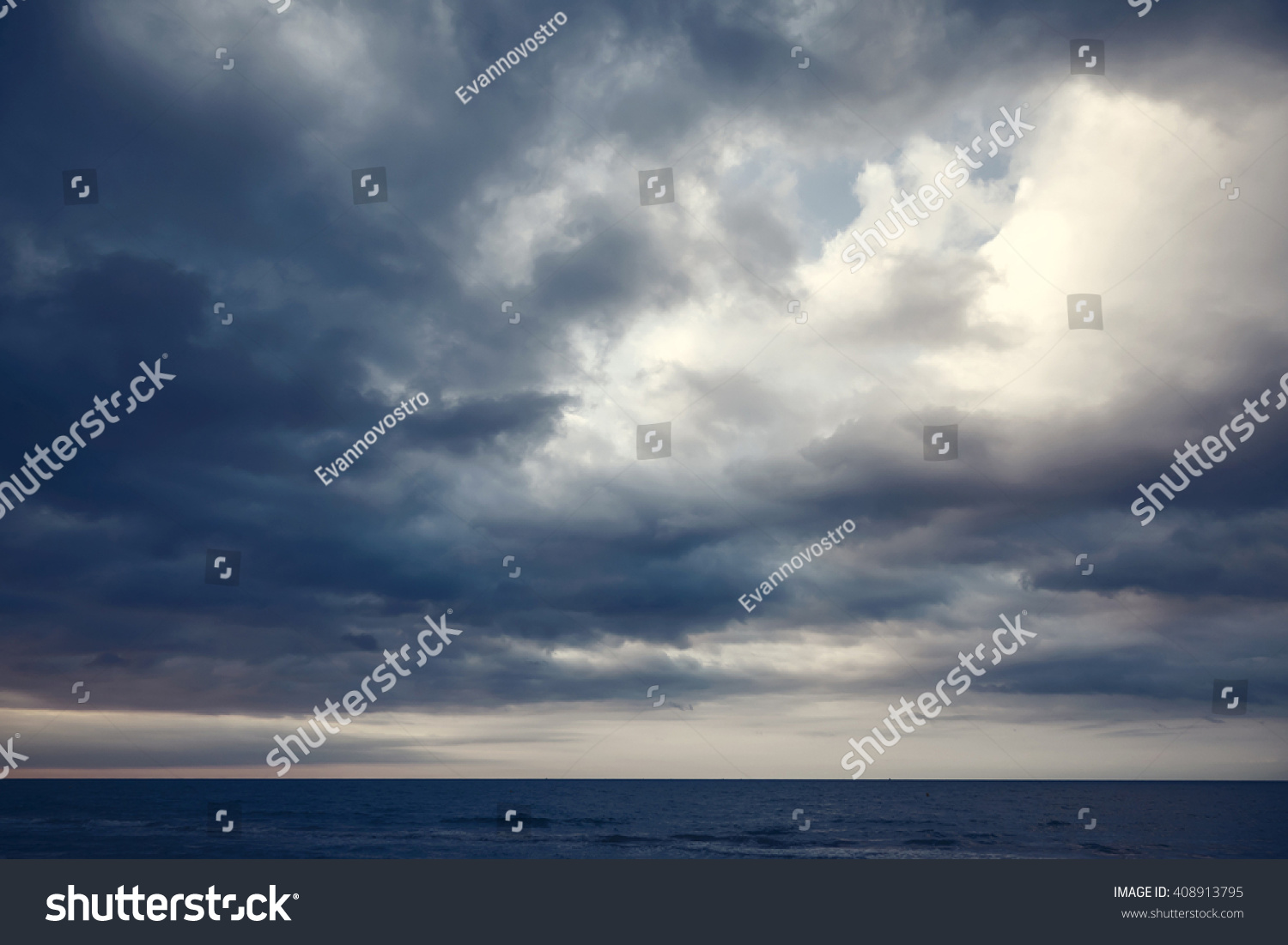 Dramatic dark cloudy sky over sea, natural photo background #408913795