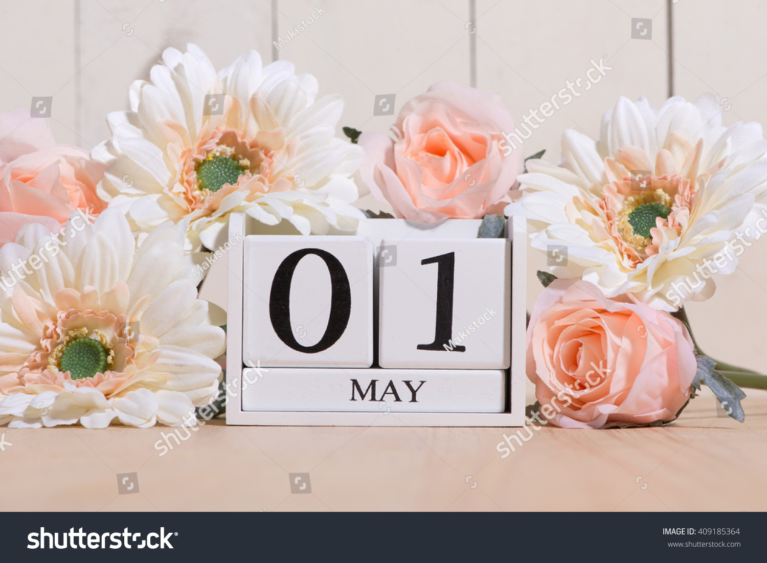 May 1st. Image of may 1 white block calendar on white background with flowers. Spring day, empty space for text. International Workers' Day #409185364