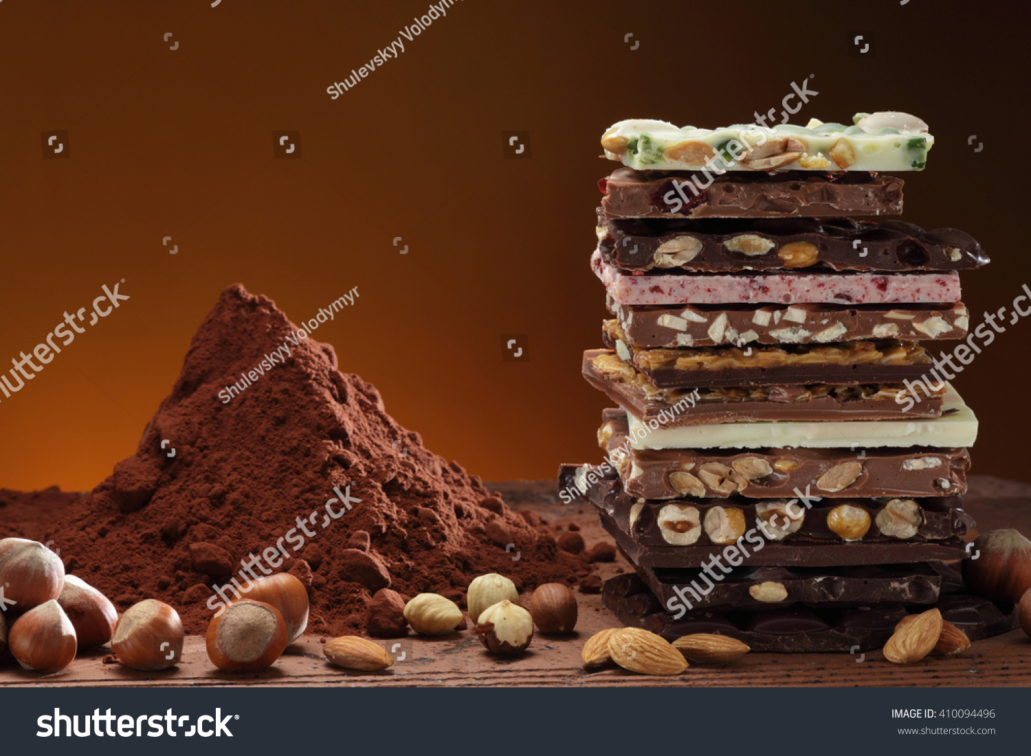  Dark and white, nut, raspberry, pitachio chocolate tower, cocoa powder heap #410094496