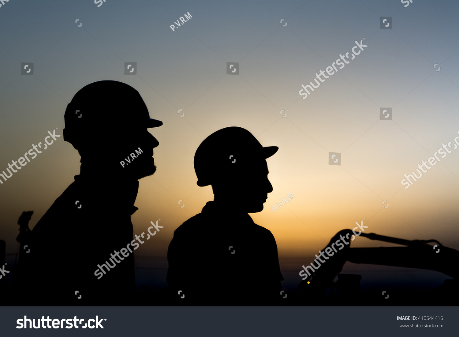Silhouette of construction workers at construction site in oilfield - Blur background with heavy lifting equipment - Sunset.    #410544415