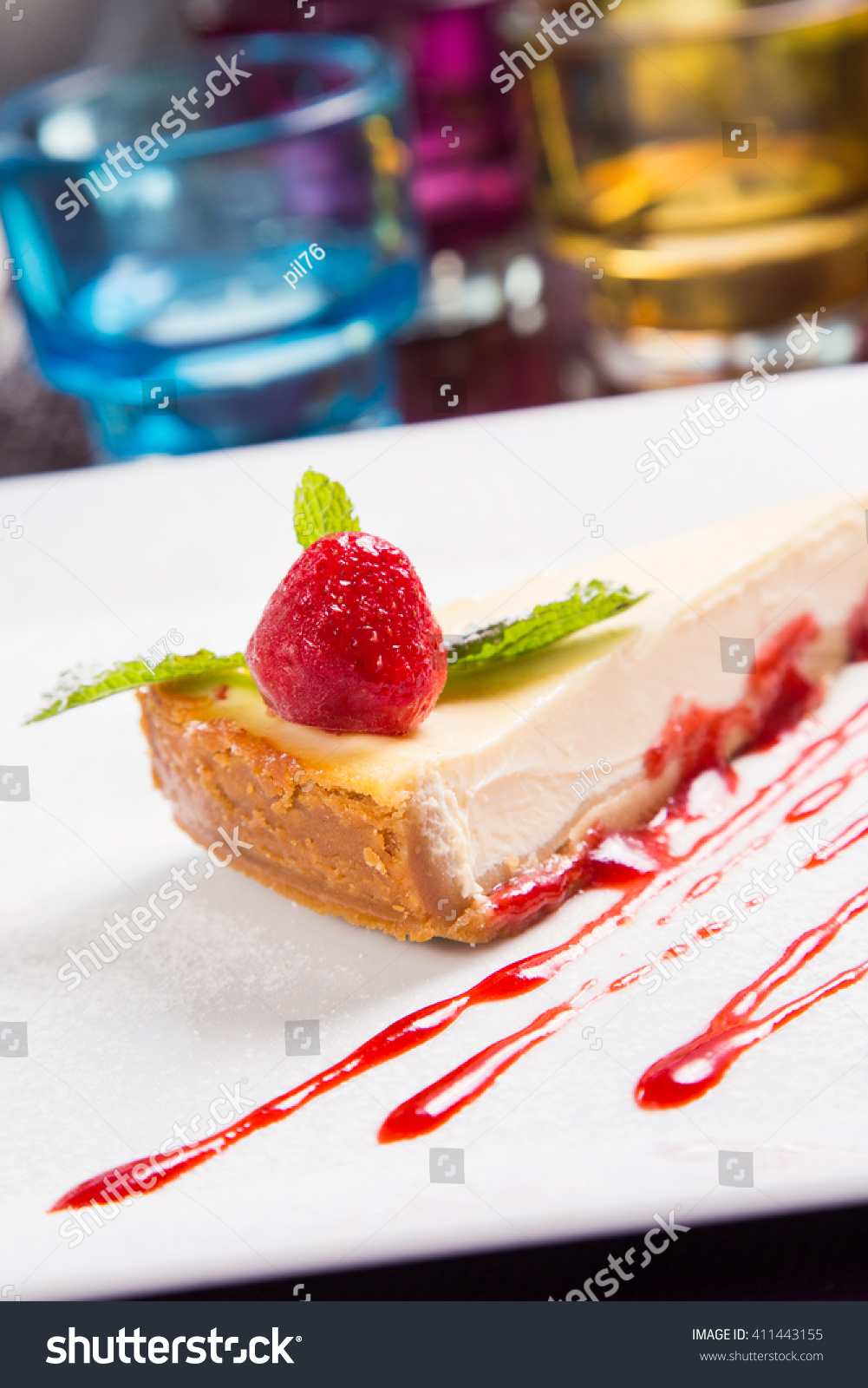 fresh creamy cheesecake with strawberry and mint on white plate #411443155