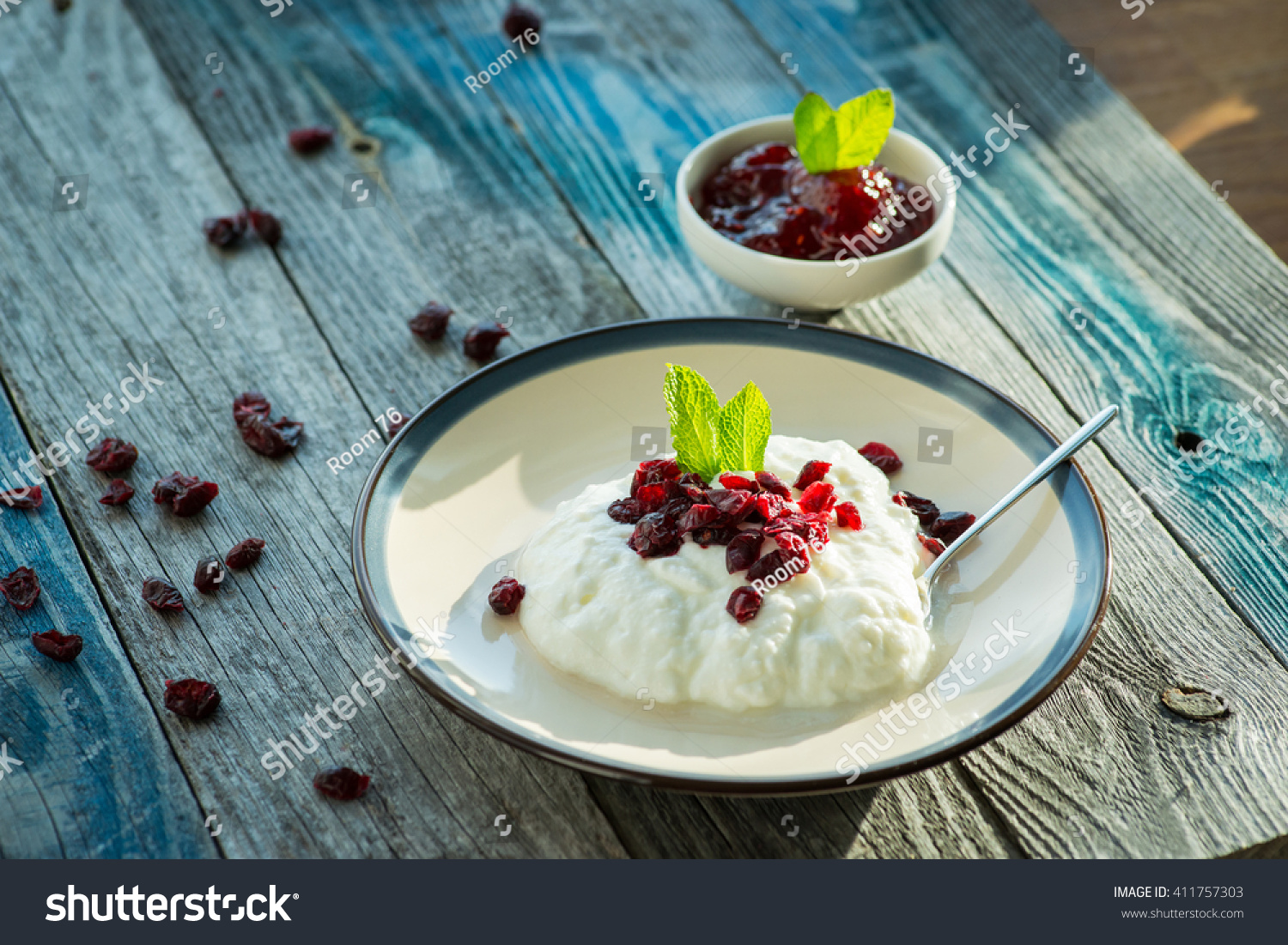 Plate with fresh yogurt on rustic wooden table #411757303