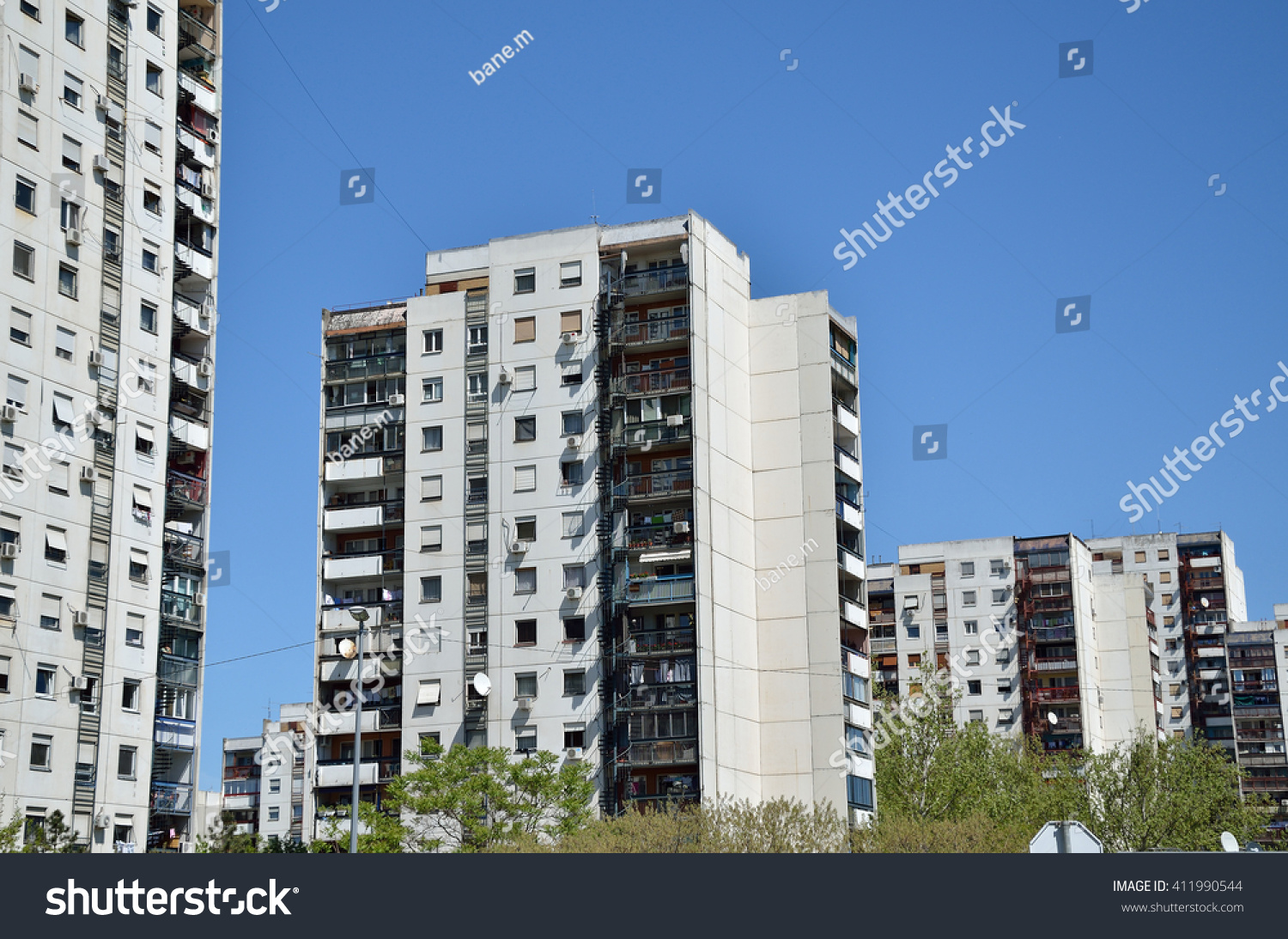 Line of residential buildings under clear spring sky #411990544