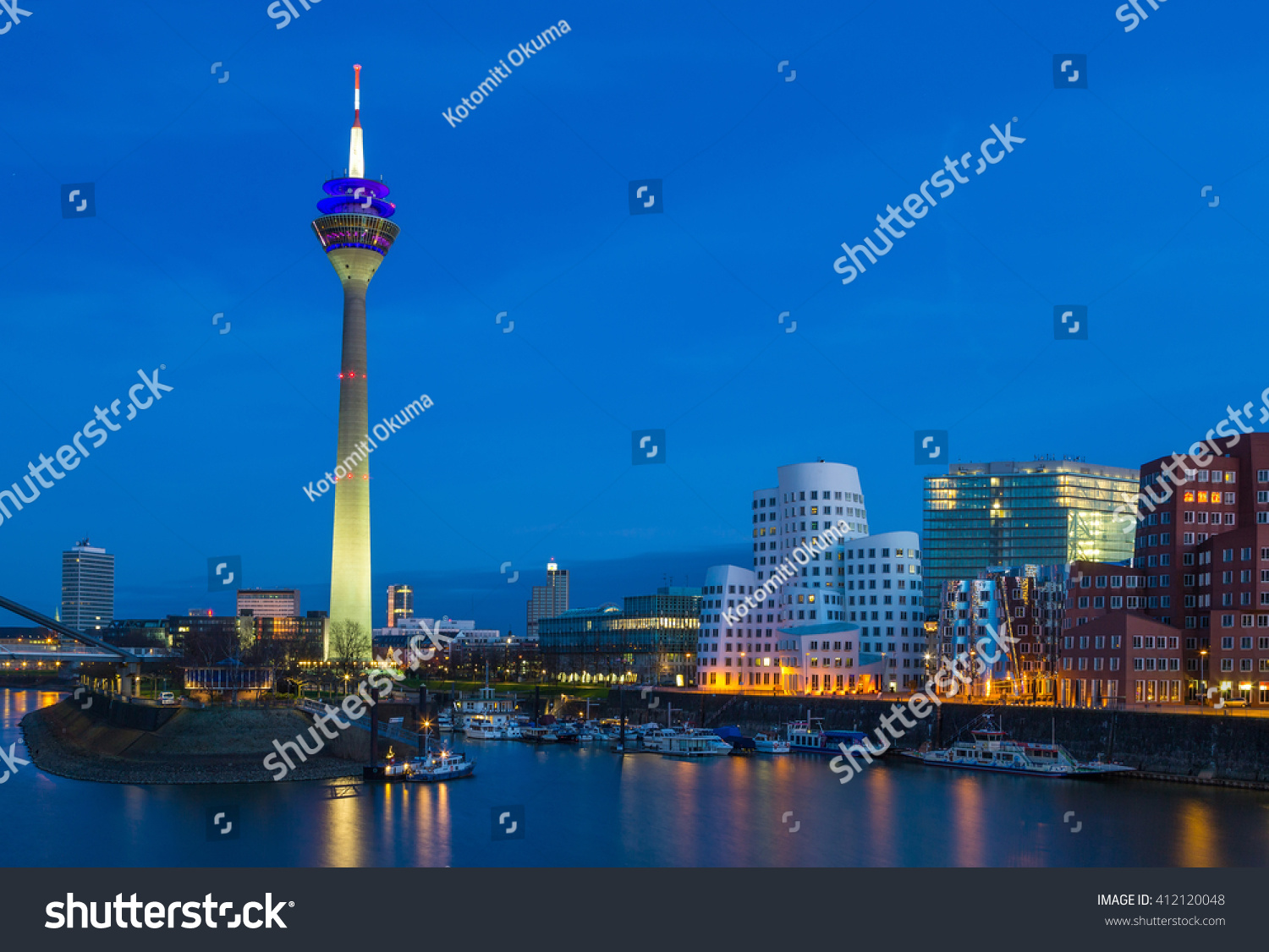 Colorful night scene of Rhein river at night in Dusseldorf. Rheinturm tower in the soft night light, Nordrhein-Westfalen, Germany, Europe. #412120048