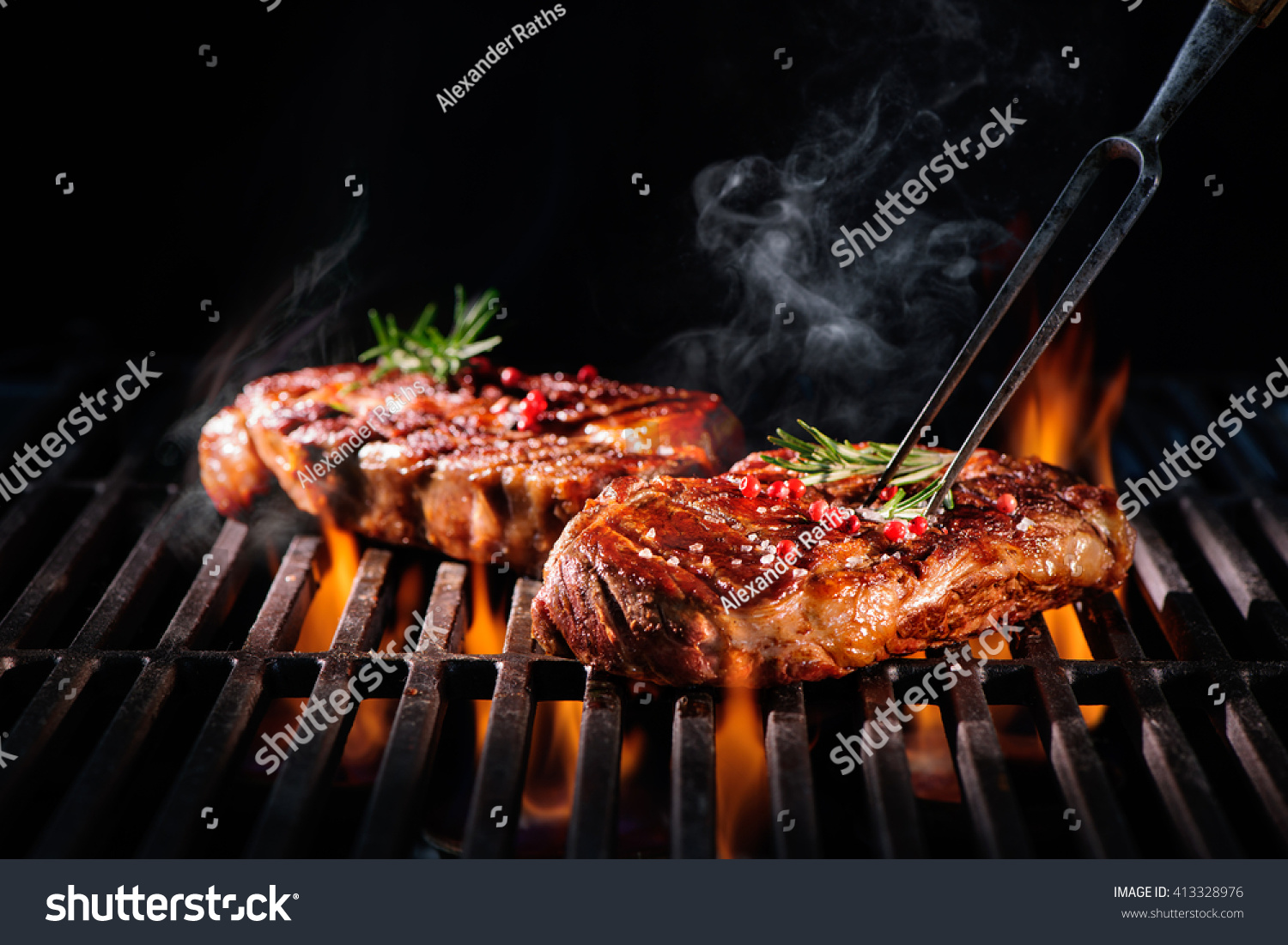 Beef steaks on the grill with flames #413328976