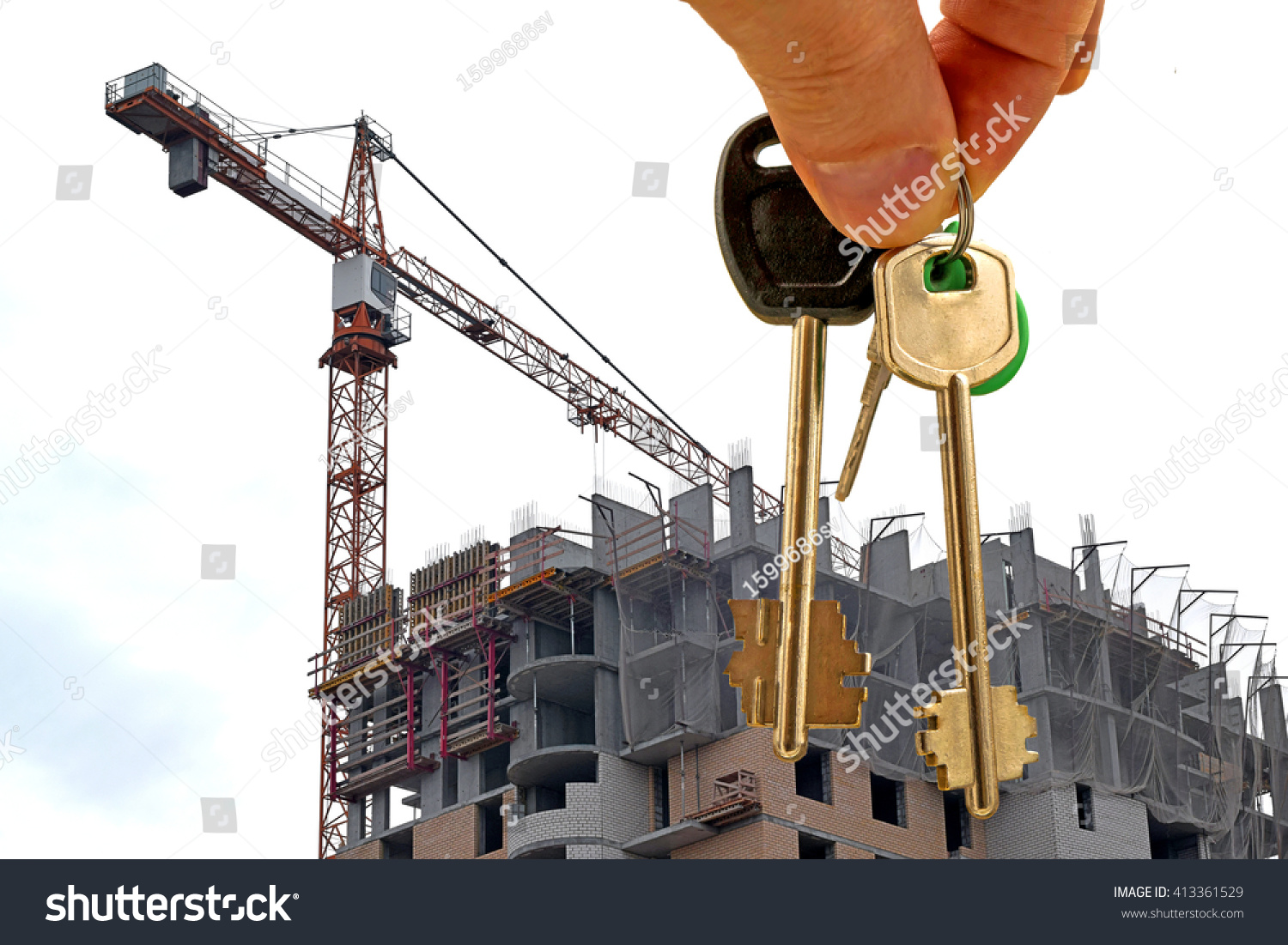 The keys to the apartment in hand on the background of houses #413361529