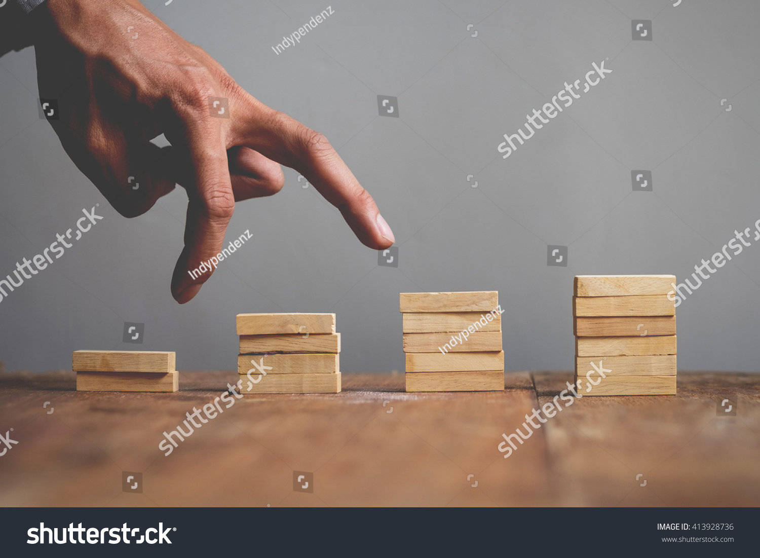 Hand liken business person jump a toy staircase to success, business concept #413928736