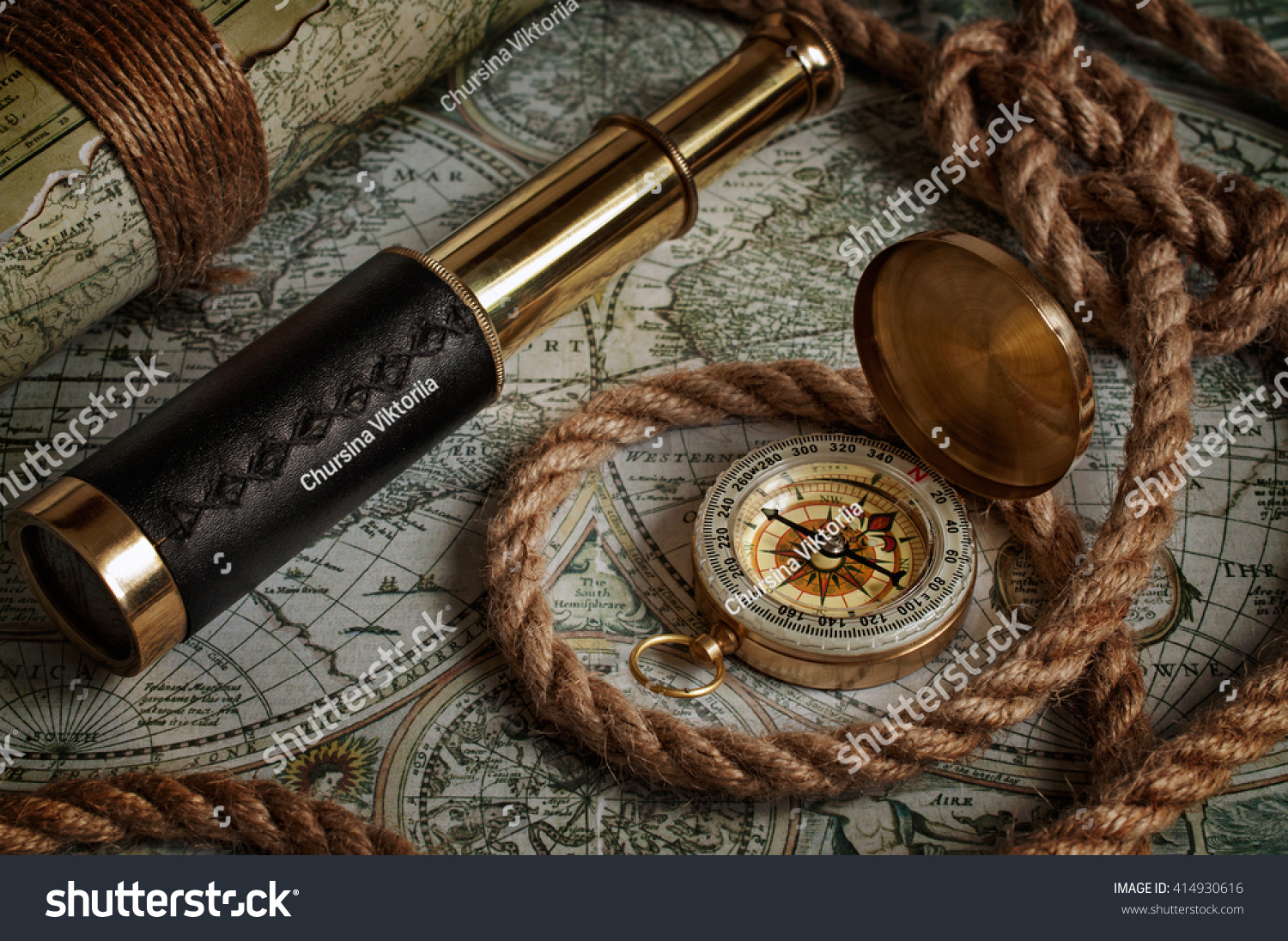 Nautical background with a navigation tools: telescope, compass and old maps #414930616