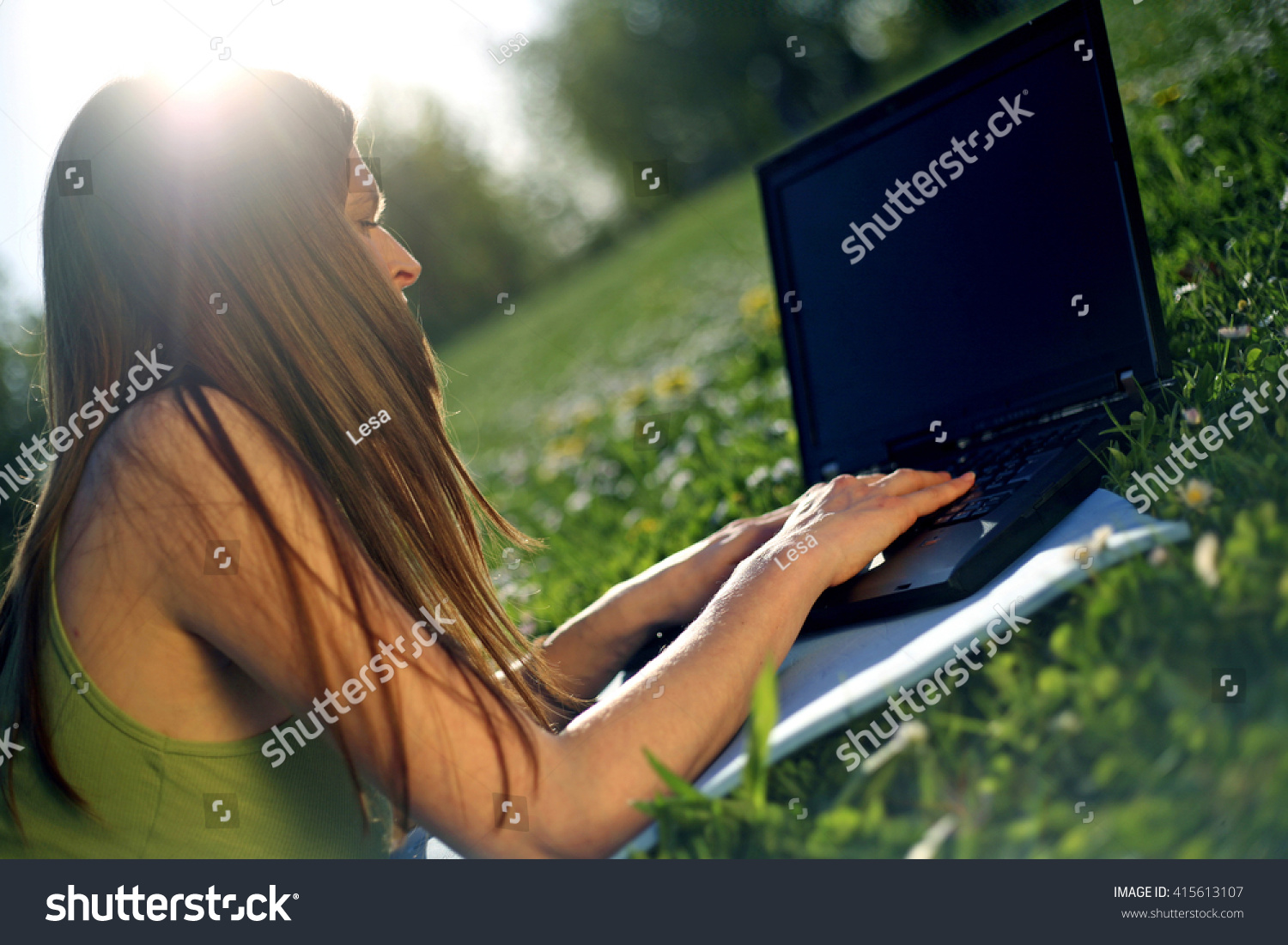Girl working on laptop in nature #415613107