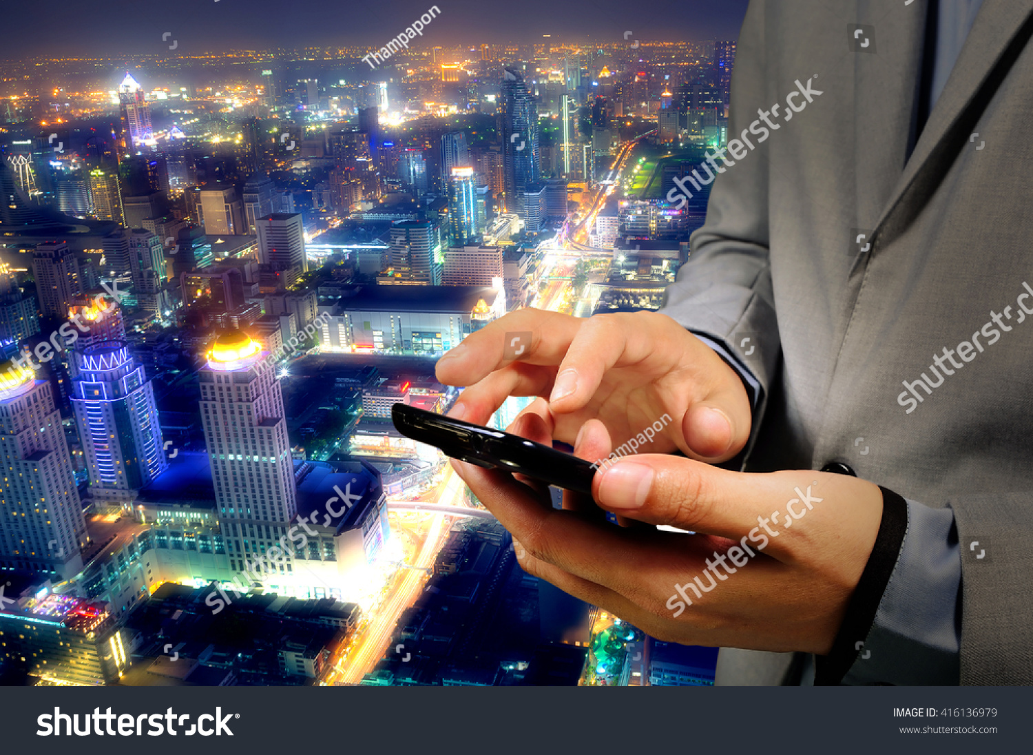 Businessman use Mobilephone or Smartphone with Modern City Background #416136979