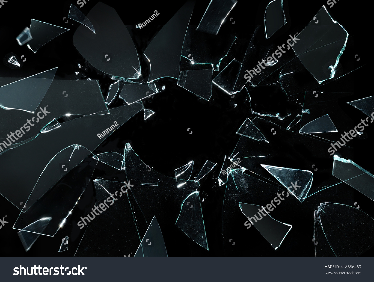 Shattered and broken glass pieces isolated on black #418656469