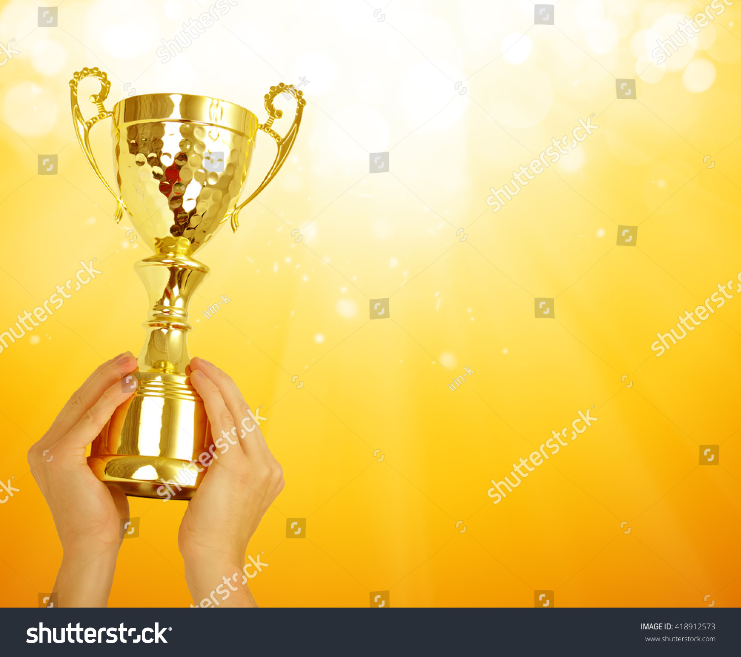 Man holding a champion golden trophy  #418912573