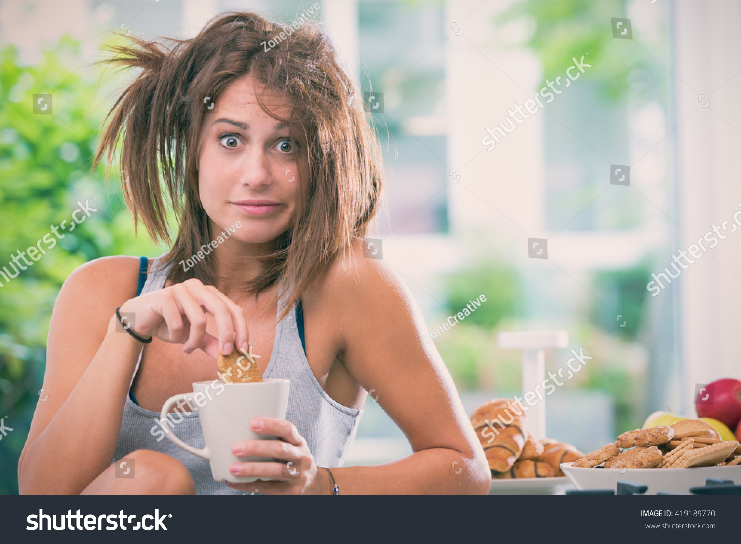 Young messy woman have breakfast in the kitchen #419189770