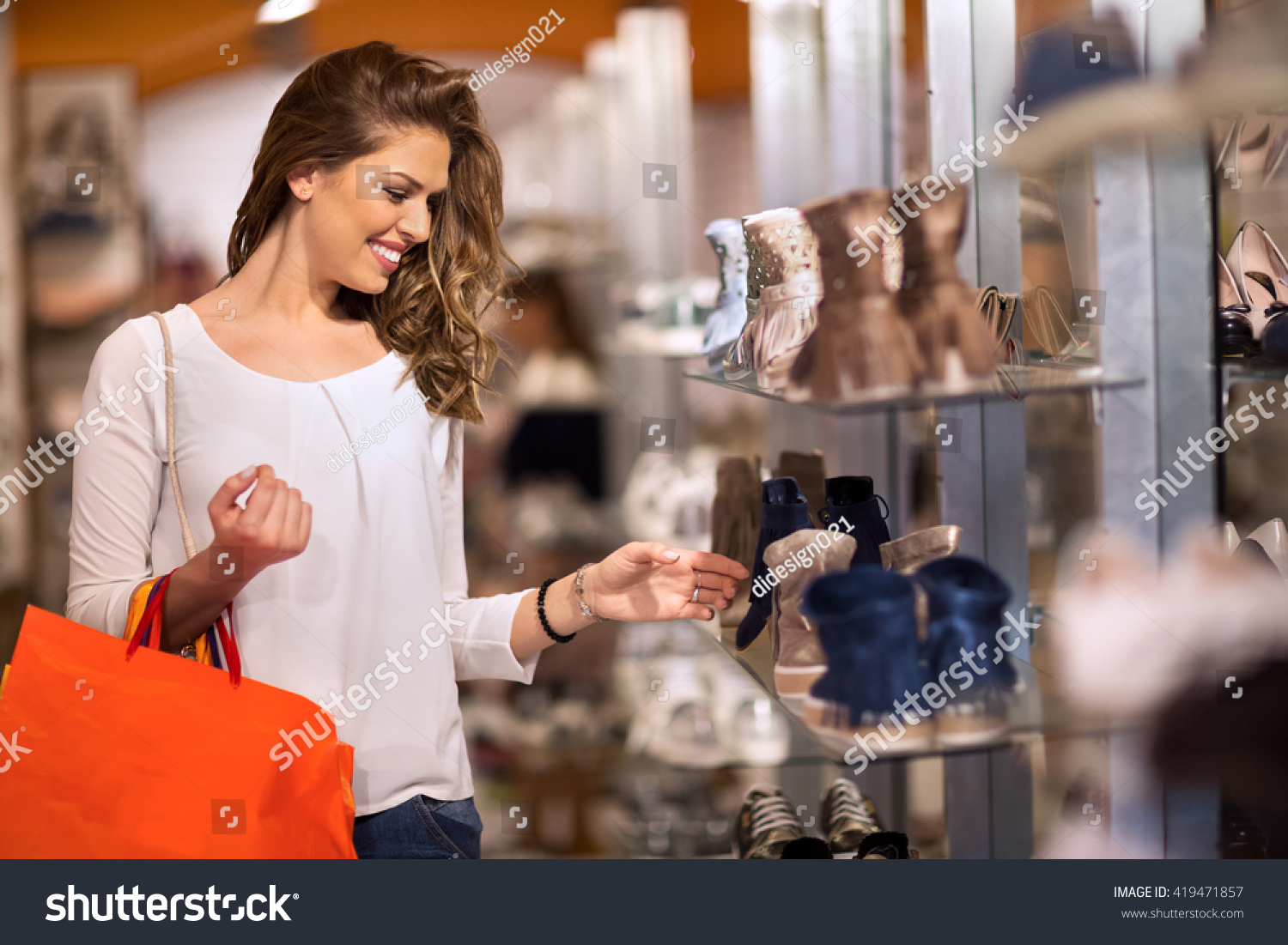 Smiling attractive young women shopping at shoes store #419471857