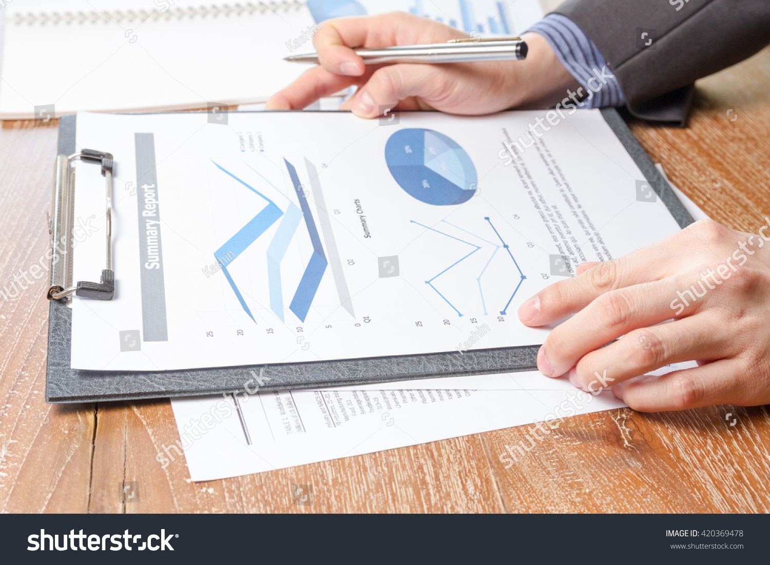 business man analyzing graph and chart document report, business performance concept #420369478