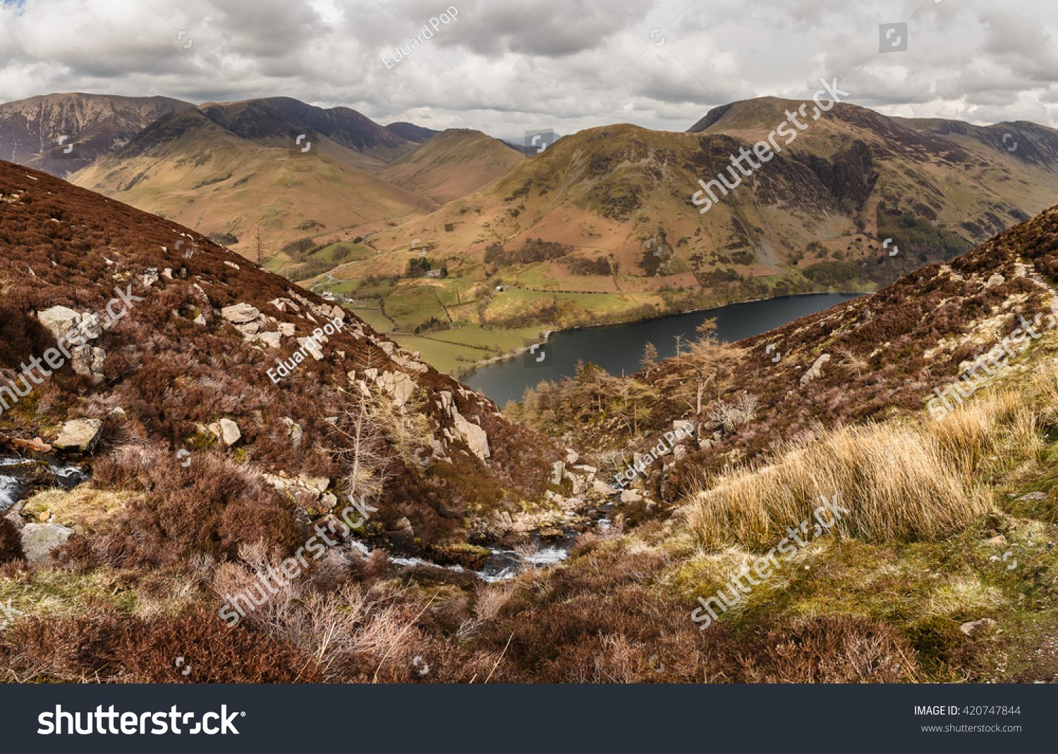 Buttermere, Lake District, as seen from the climb to High Stile. A small stream runs from the tarn to a waterfall #420747844