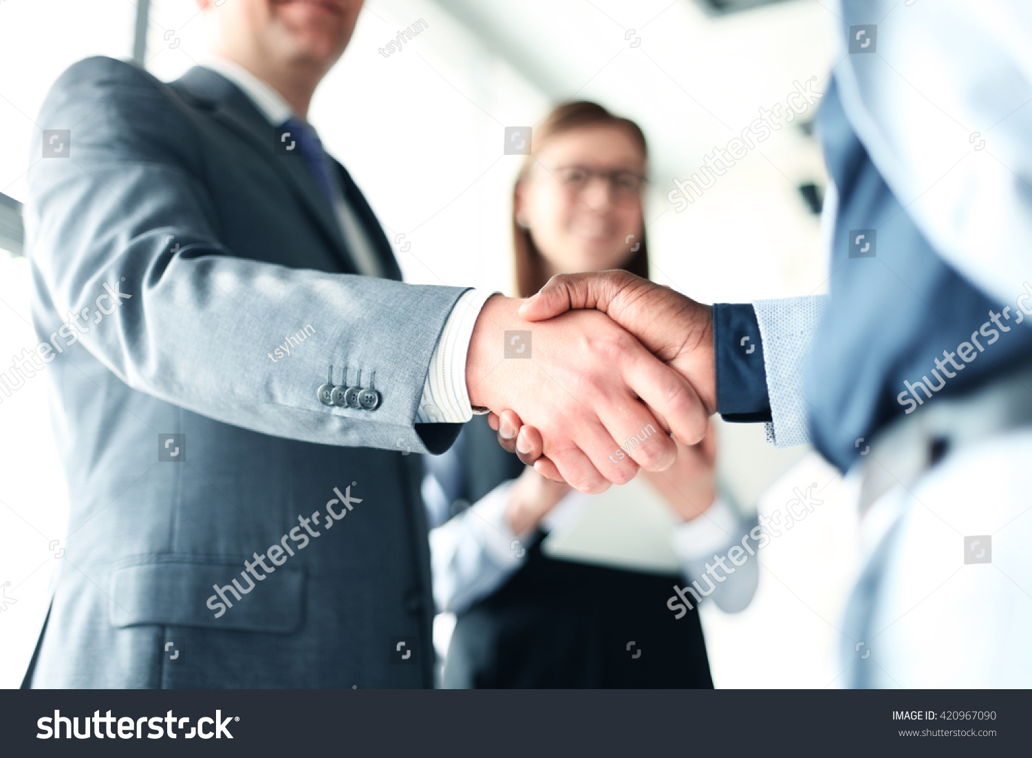 Business people shaking hands, finishing up a meeting #420967090