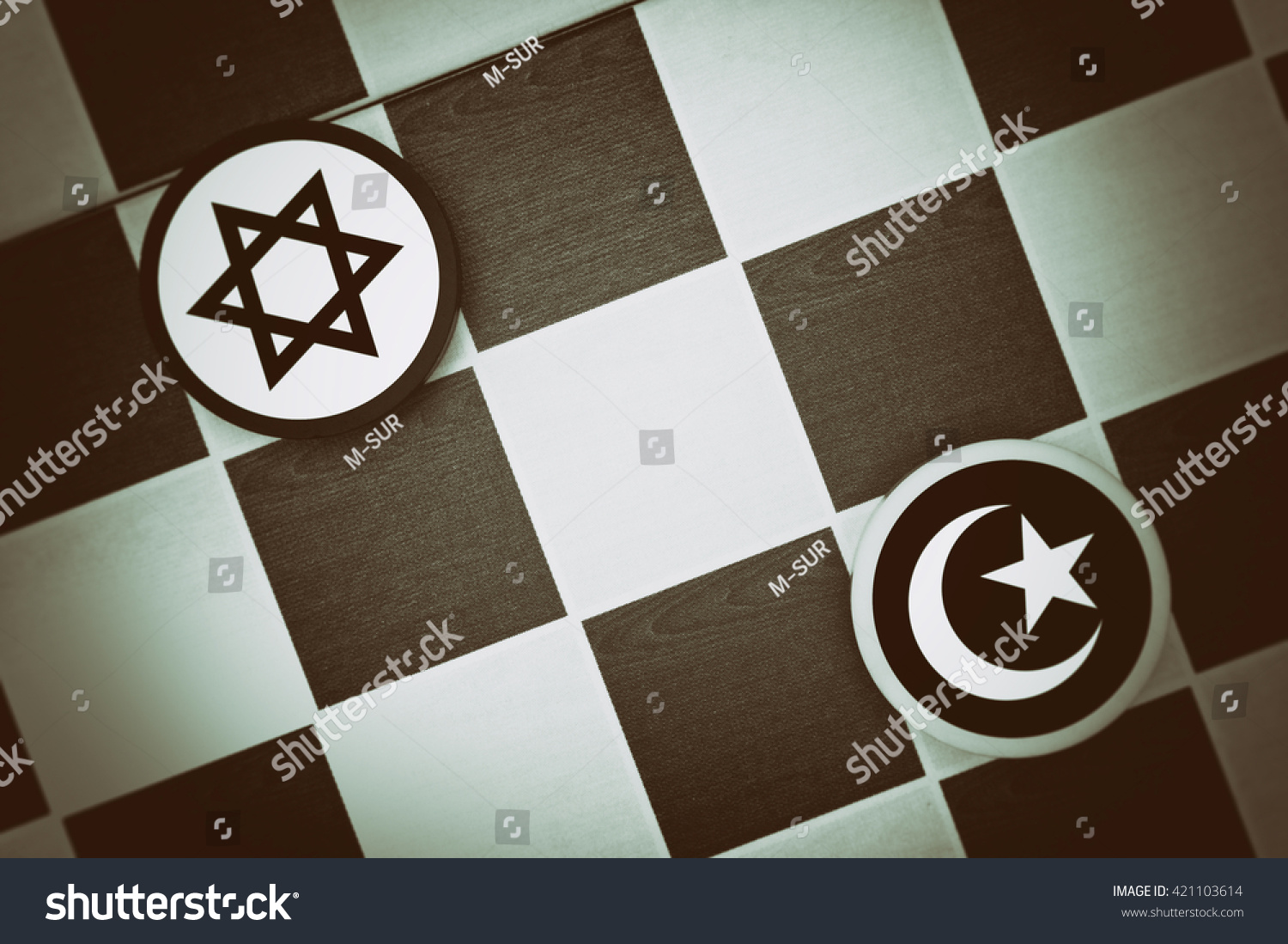 Draughts (Checkers) - Jadaism vs Islam - religious tension and conflict between two monotheistic religions and believers, jews and muslims (dramatic light: underexposure, vignetting) #421103614