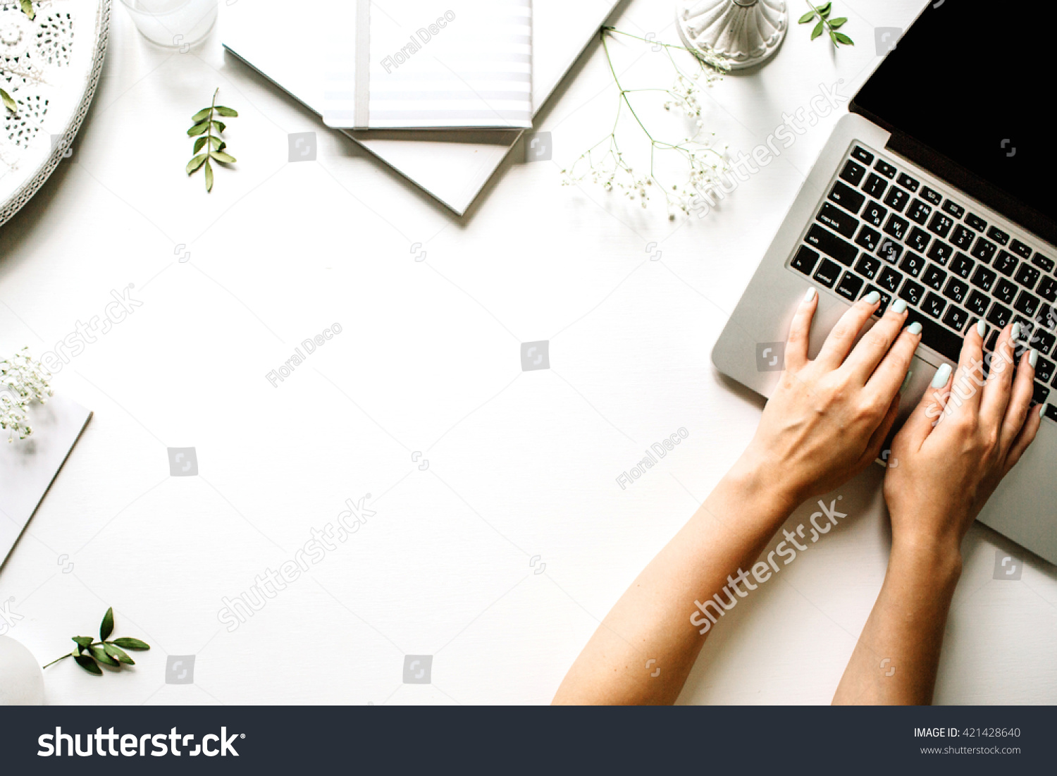 Workspace with laptop, girl's hands, notebook, sketchbook, white vintage tray, candlesticks on white background. Flat lay, top view office table desk. Freelancer working place #421428640