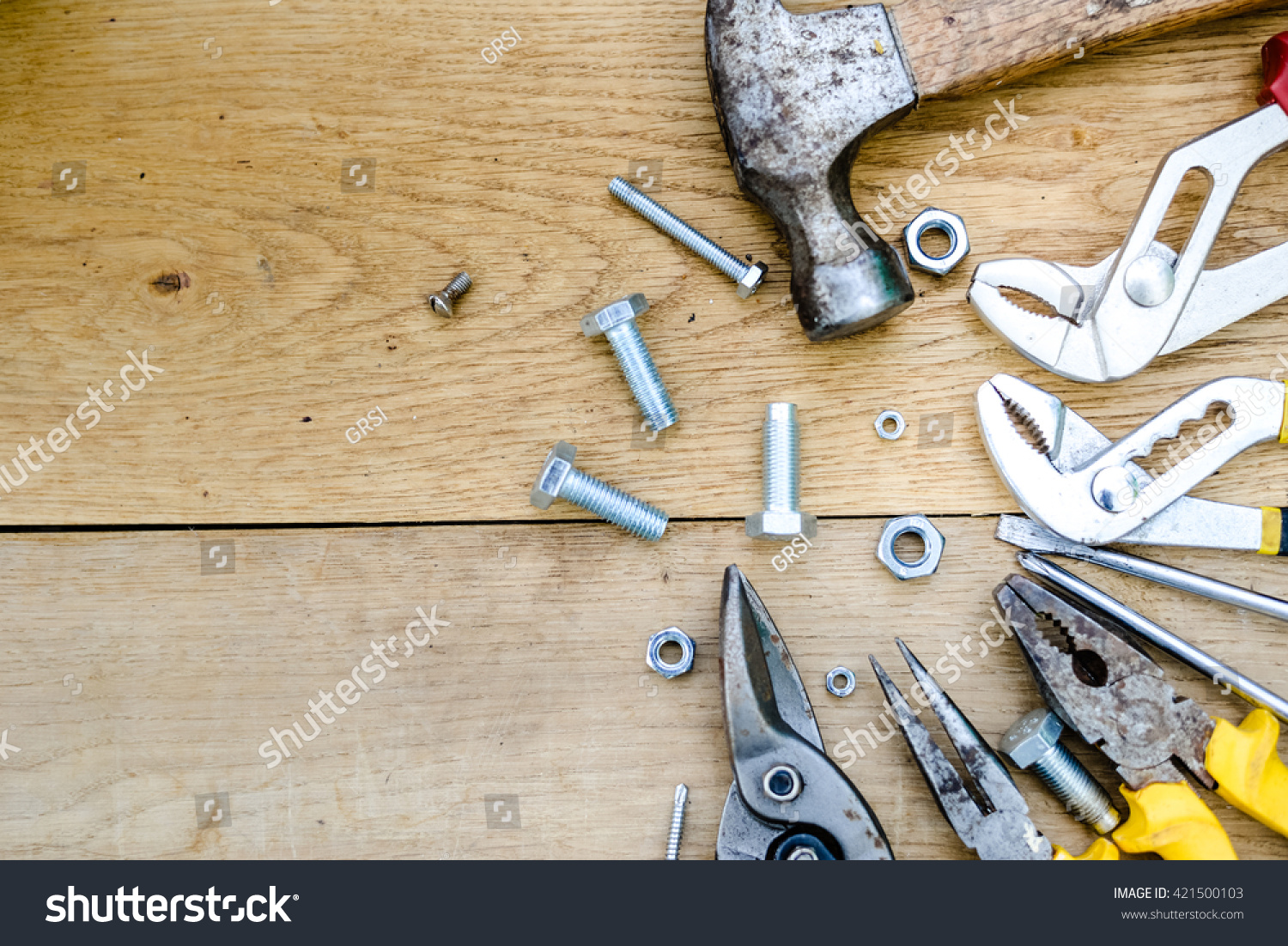 Closeup flat lay of tools on a wooden surface texture, top view #421500103