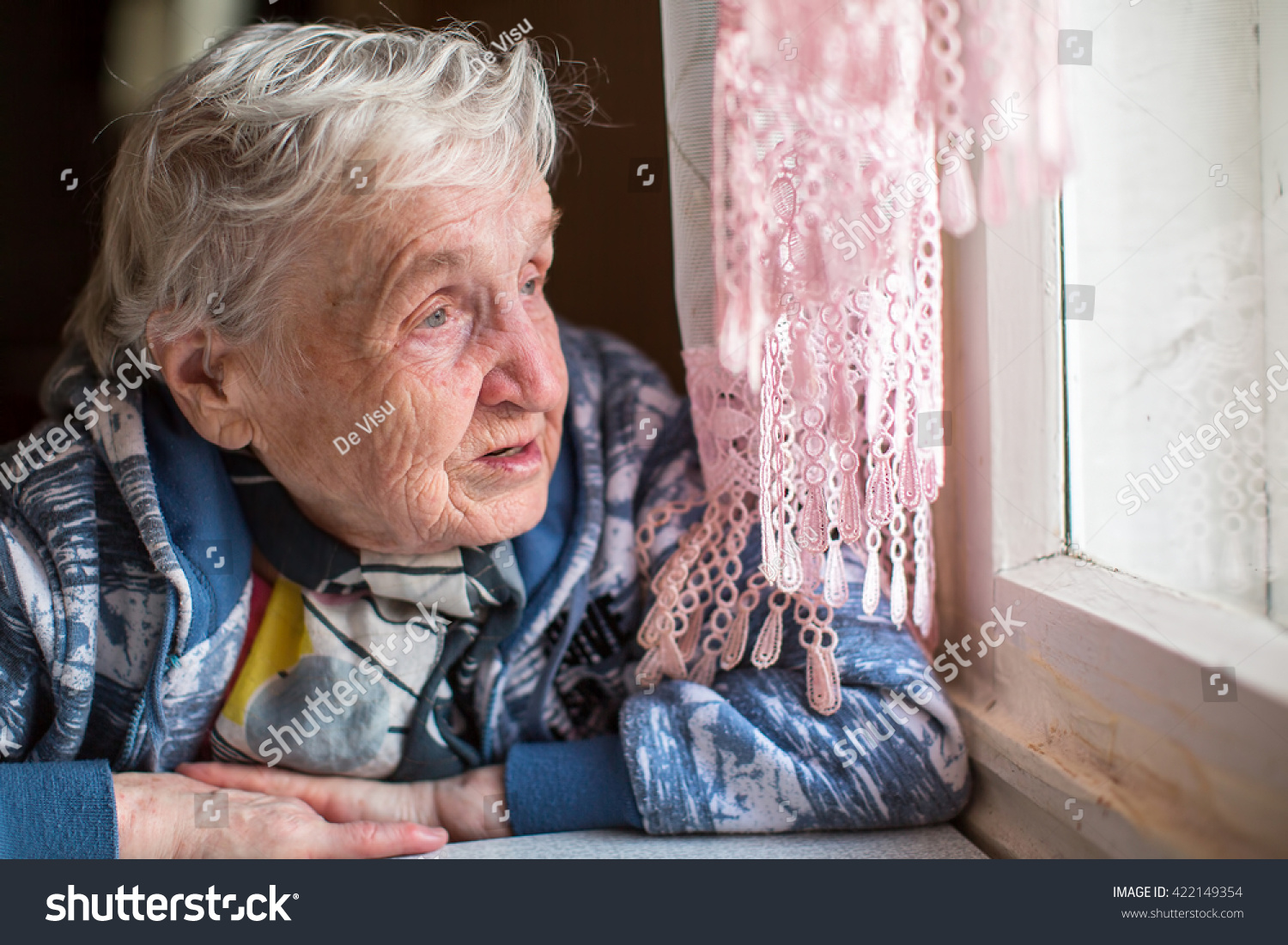 An elderly woman near the window. #422149354