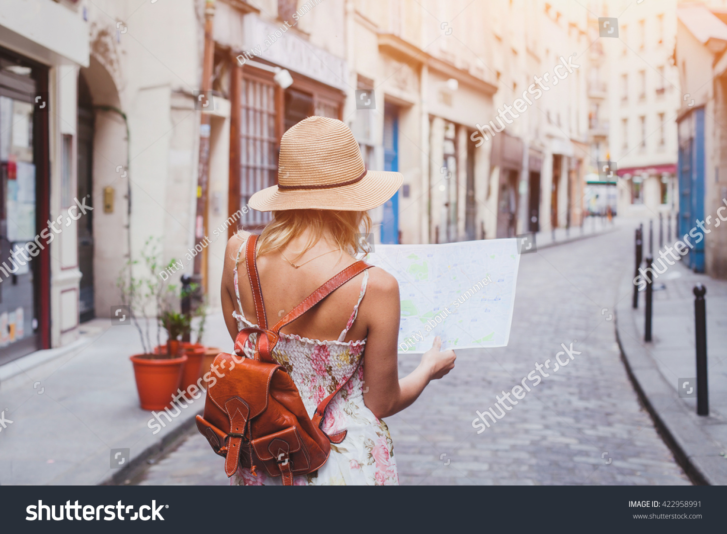 travel guide, tourism in Europe, woman tourist with map on the street #422958991