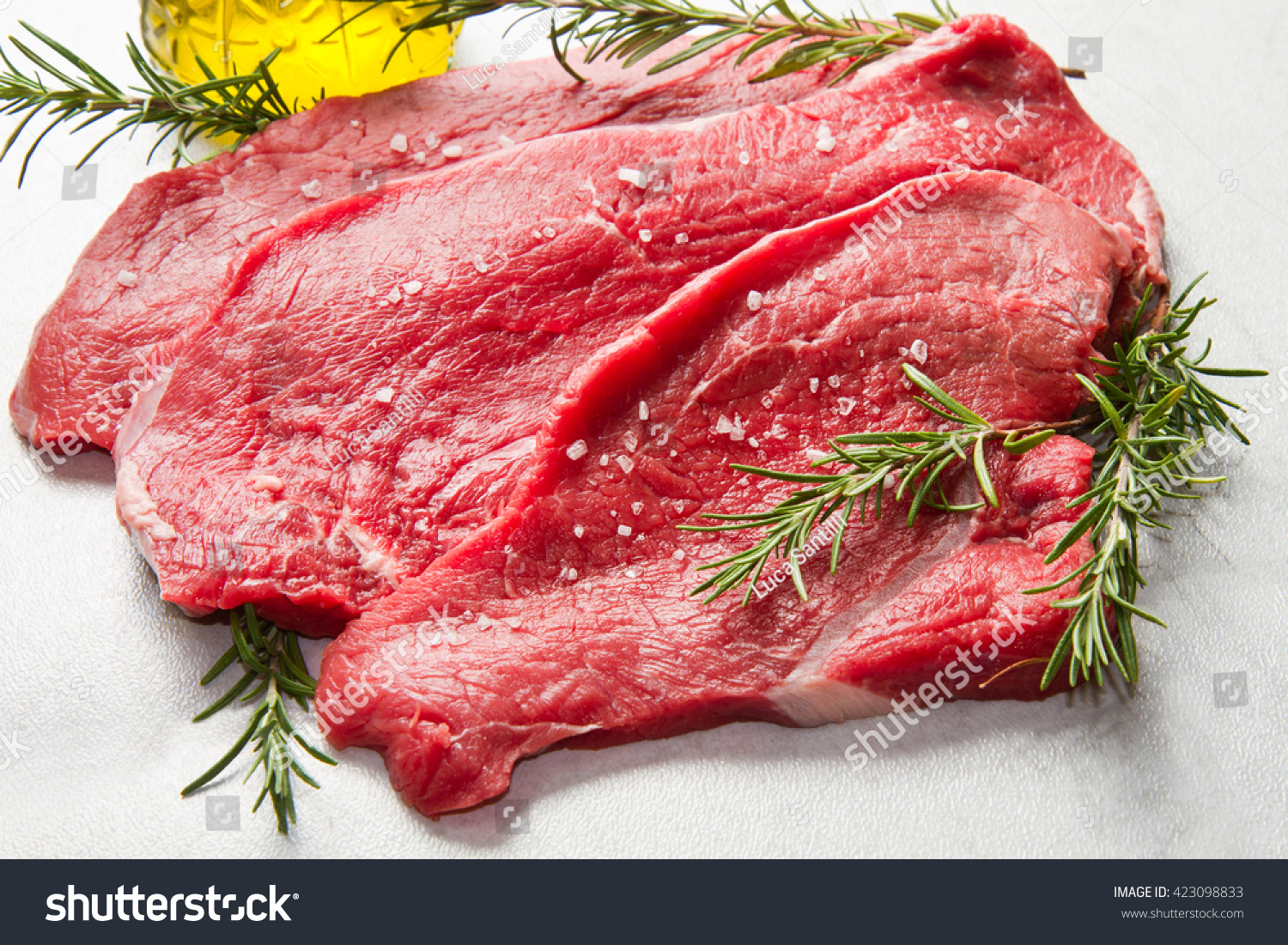 a red meat with rosemary on marble table #423098833