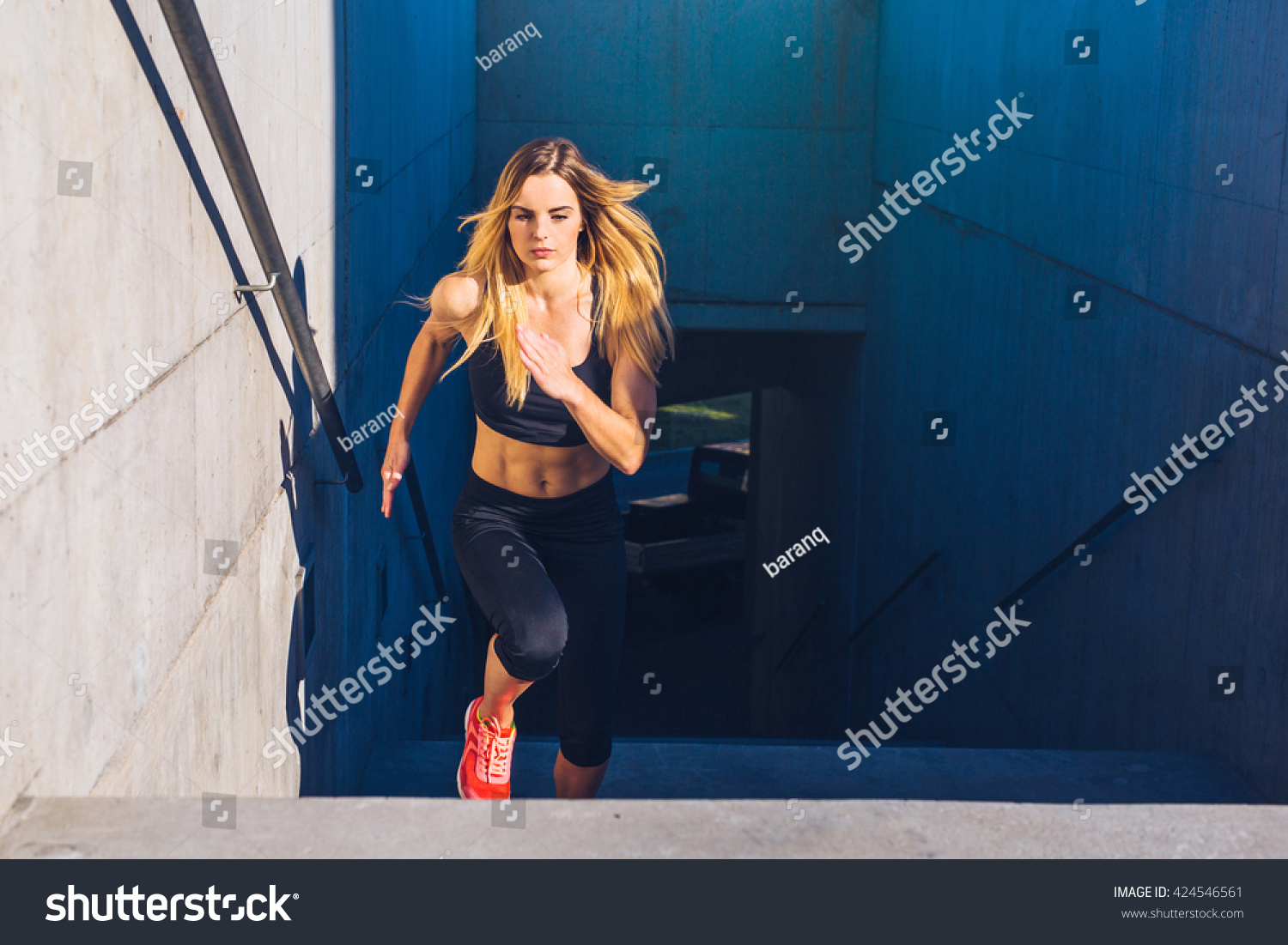 Female athlete running fast up the stairs - staircase workout #424546561