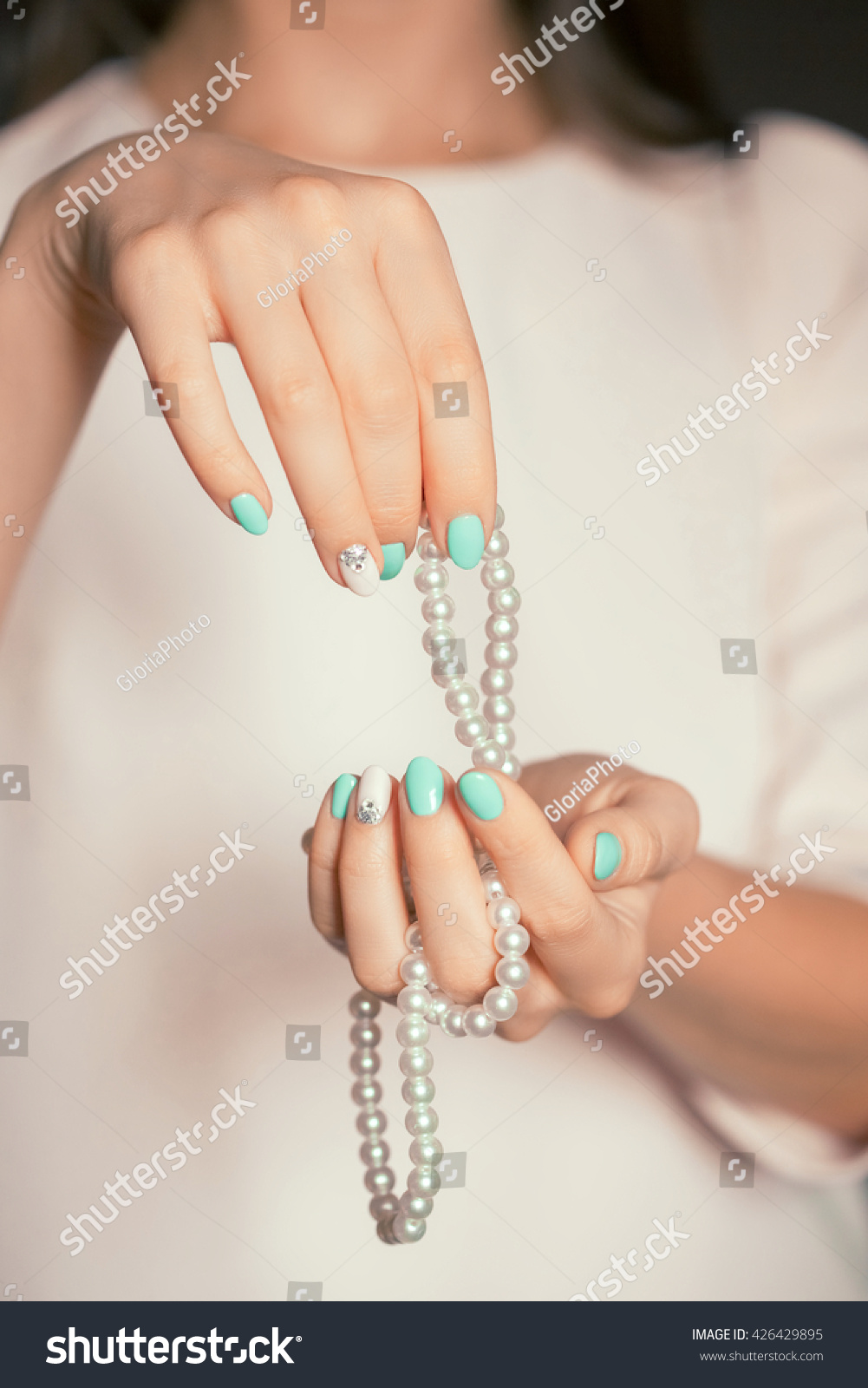 Beauty female fingernails with turquoise and white french diamond manicure and pearl #426429895