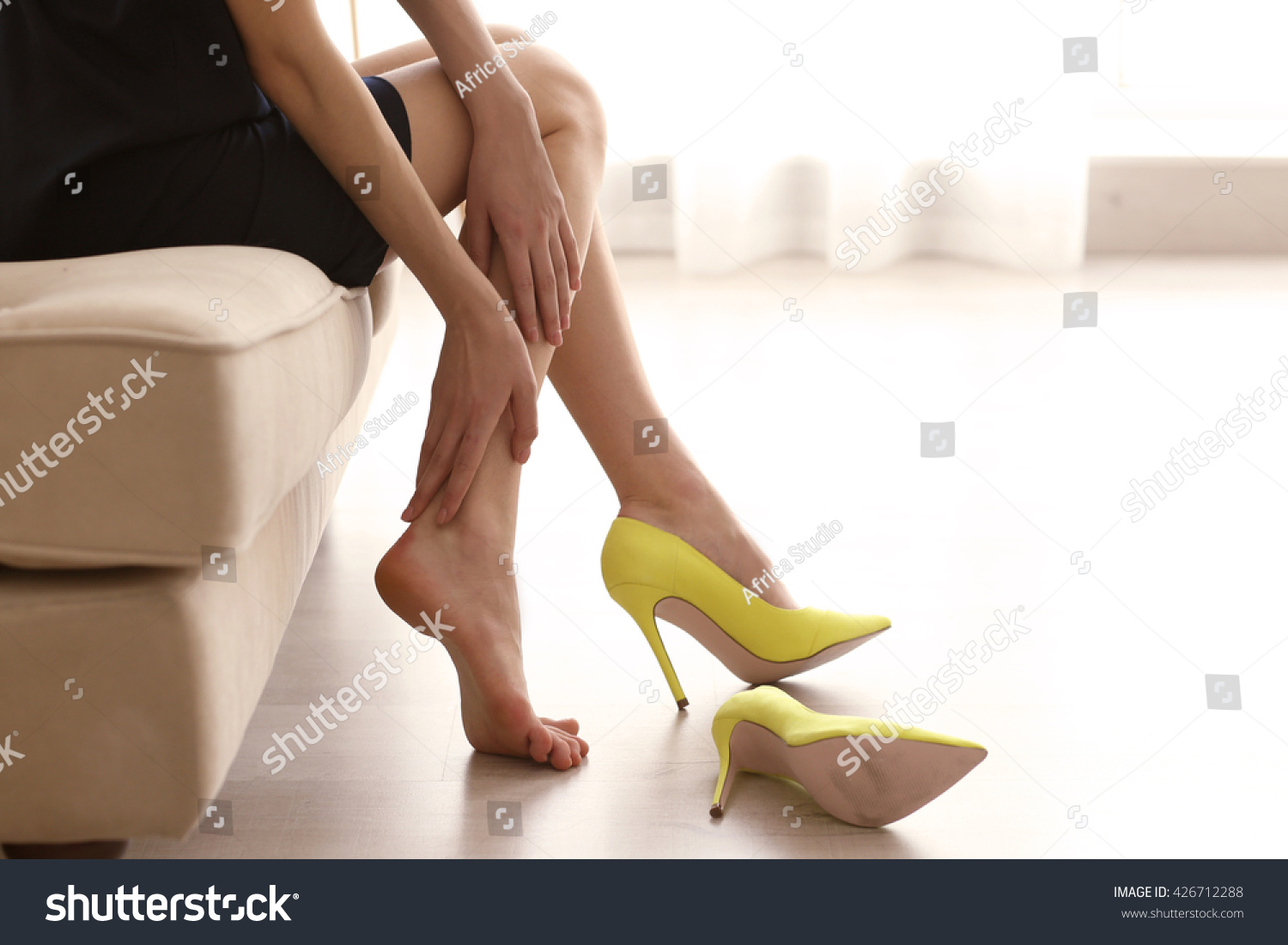 Woman in yellow high heels shoes. #426712288