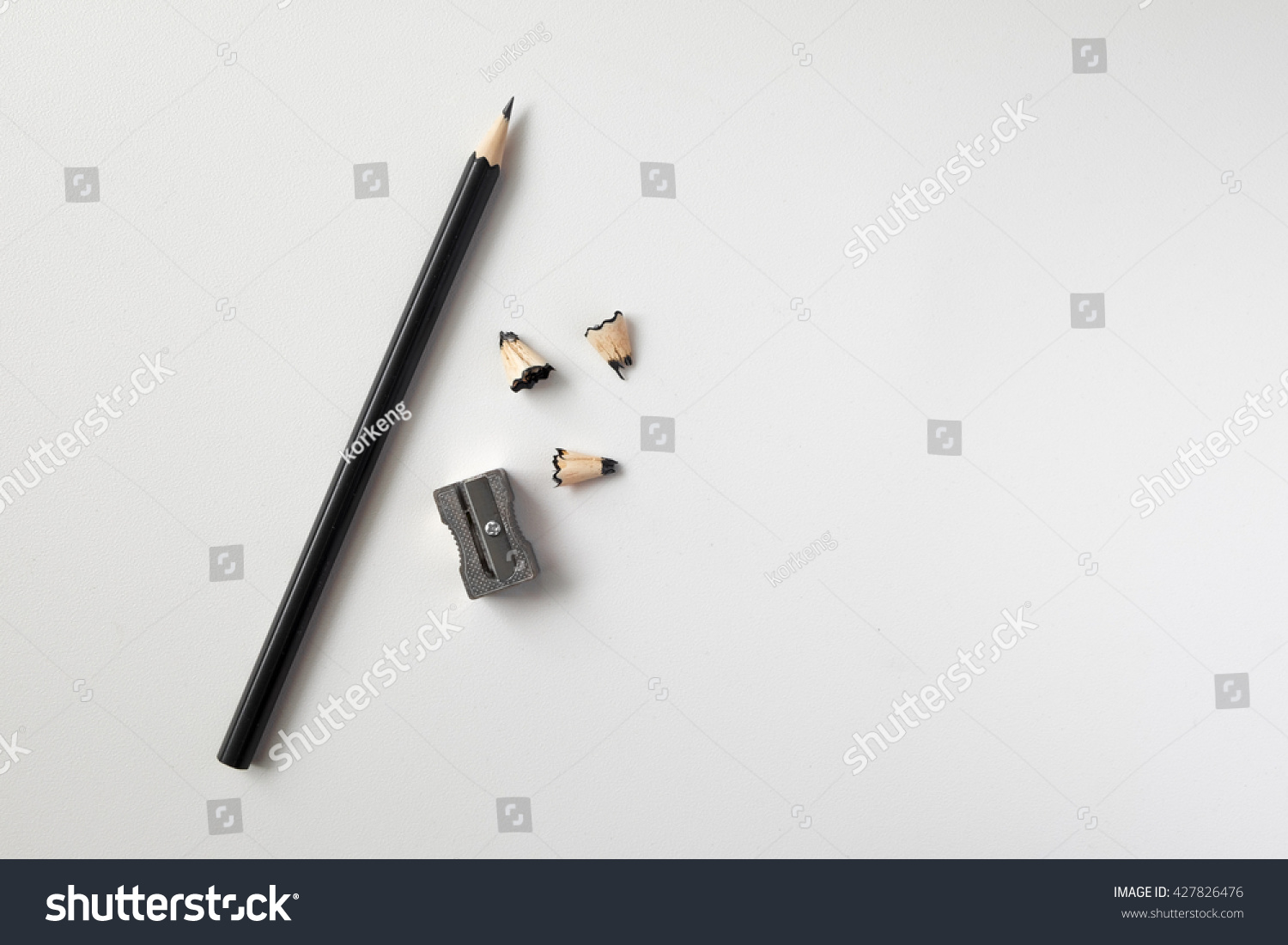 Pencil with sharpening shavings on white background #427826476