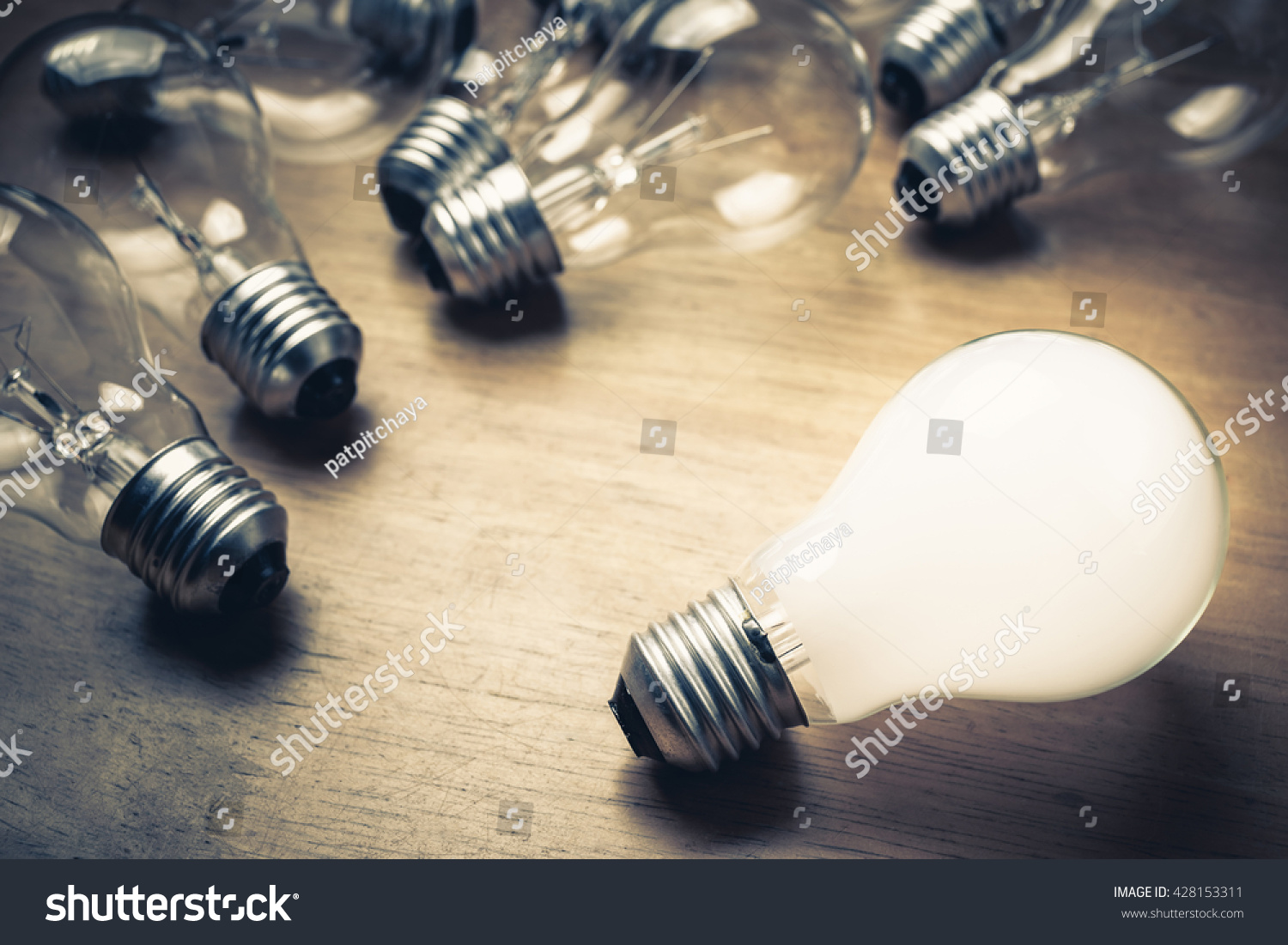 White light bulb glowing separate from the others #428153311